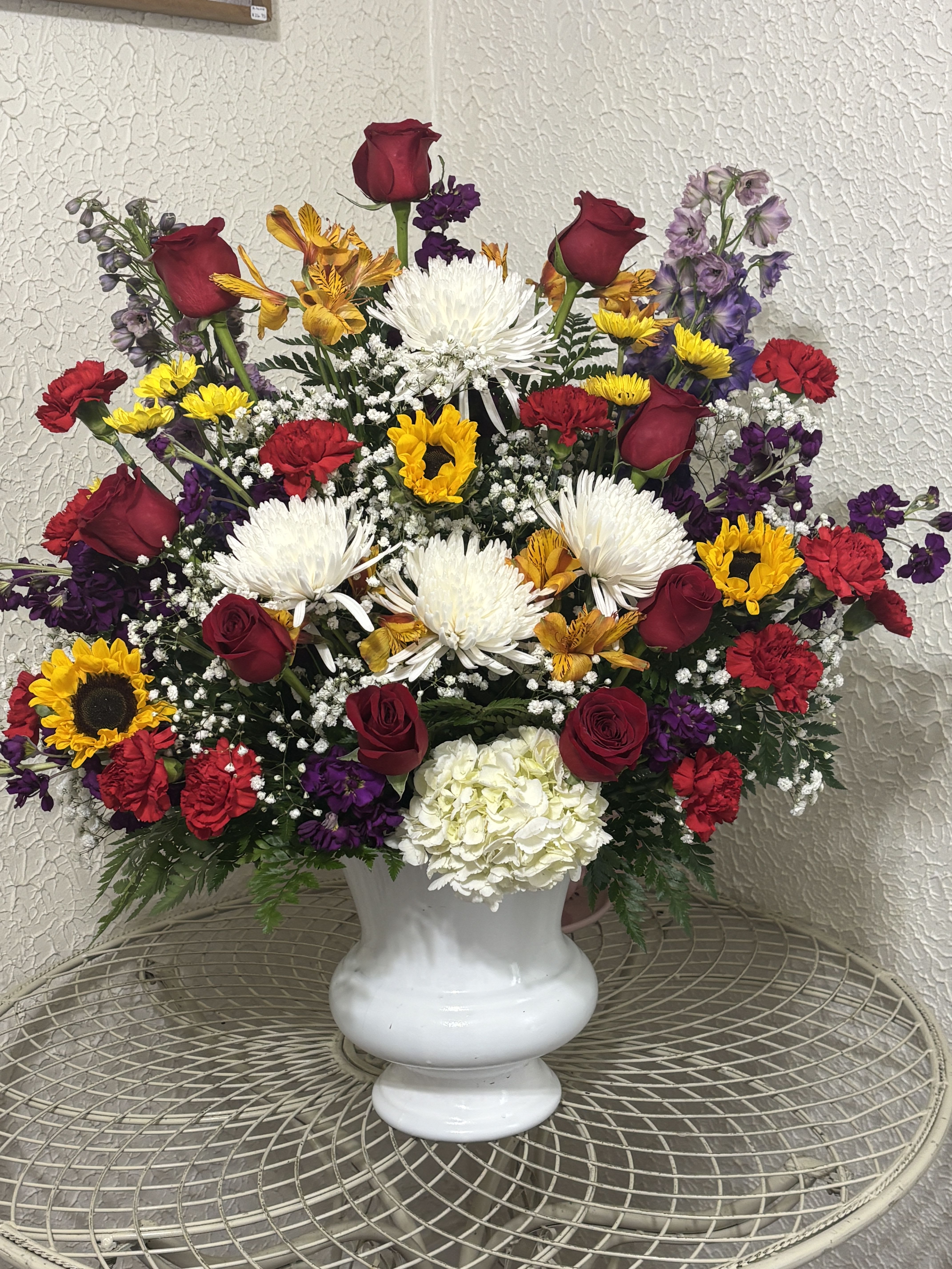 American Pride - Magnificent sympathy floral arrangement that stuns and is perfect when a smaller arrangement just will not show how much we love you. 30" tall with a large number of flowers of various kinds. Contains roses lilies, carnations, and other seasonal flowers
