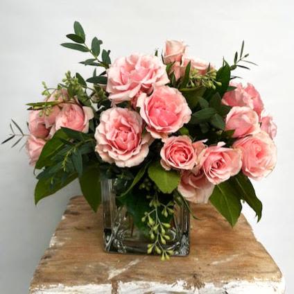 Simply Sweetheart - A Charming Touch of Sweetness The "Simply Sweetheart" arrangement features tiny pink roses beautifully arranged in a clear glass cube, creating a delightful and charming display. This petite bouquet is perfect for adding a touch of elegance to a bedside table or any cozy corner of your home. Delicate Design: The soft pink hues of the roses bring a gentle and soothing ambiance, ideal for creating a serene atmosphere. Versatile Placement: Its compact size makes it perfect for small spaces, such as a bedside table, desk, or windowsill, where it can be enjoyed daily. Natural Beauty: The natural foliage adds a rustic charm, enhancing the natural beauty of the roses. Choose the "Simply Sweetheart" from Elizabeth's Garden to bring a touch of natural beauty and elegance into your home, perfect for personal enjoyment or as a thoughtful gift.