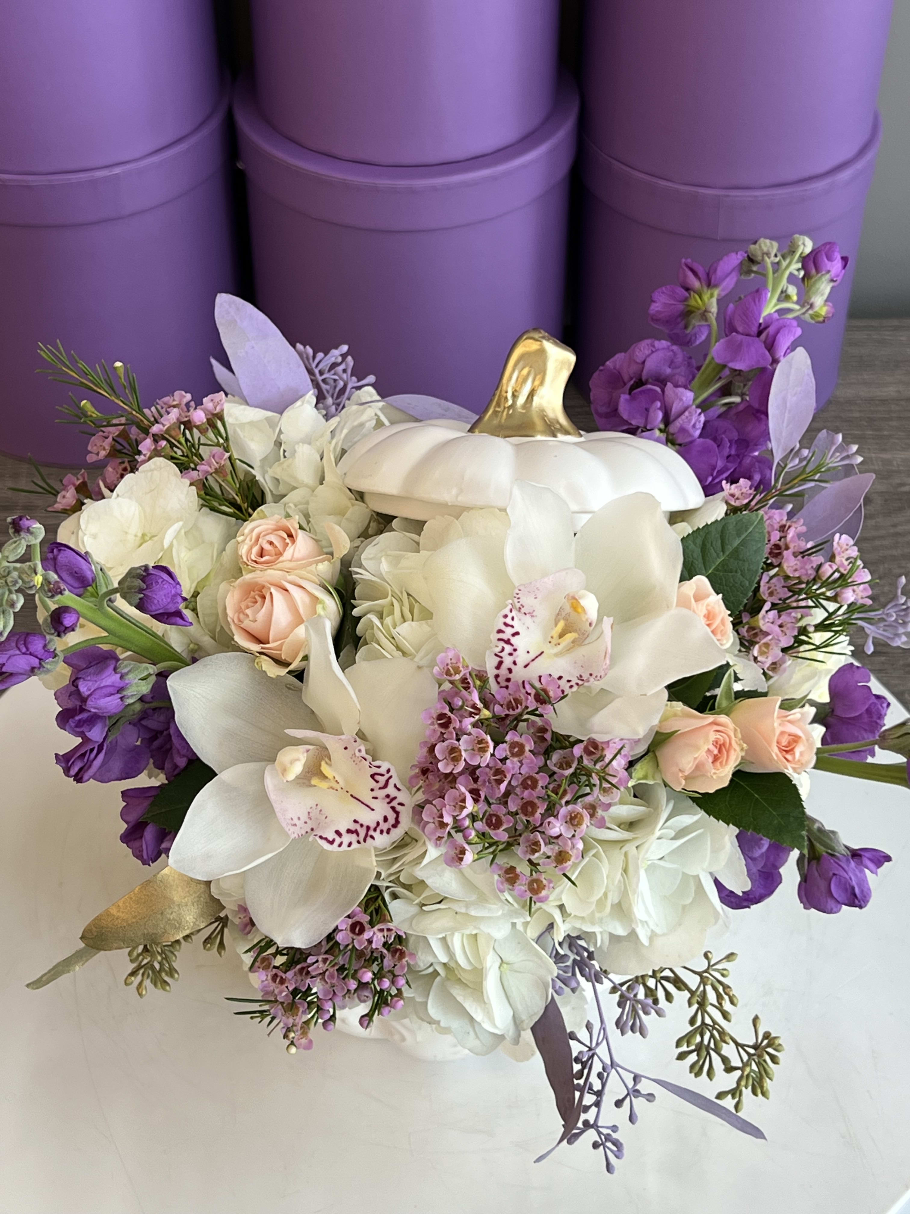 Ceramic Pumpkin With Fresh Flowers ™ - This enchanting arrangement is presented in a chic white pumpkin vase, blending seasonal charm with elegant sophistication. Overflowing with fluffy white hydrangeas, creamy lilies, soft blush roses, and delicate lavender blooms, it creates a dreamy mix of pastel and purple hues. The unique pumpkin base adds a playful yet stylish twist, making it perfect for autumn celebrations, gifts, or elegant home décor.