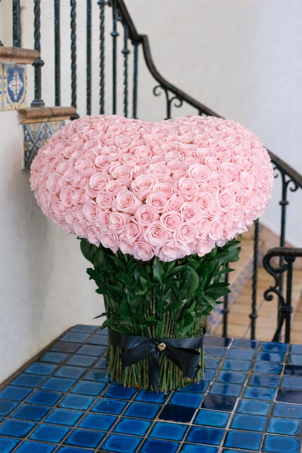 Large pink rose arrangement with a black ribbon tie