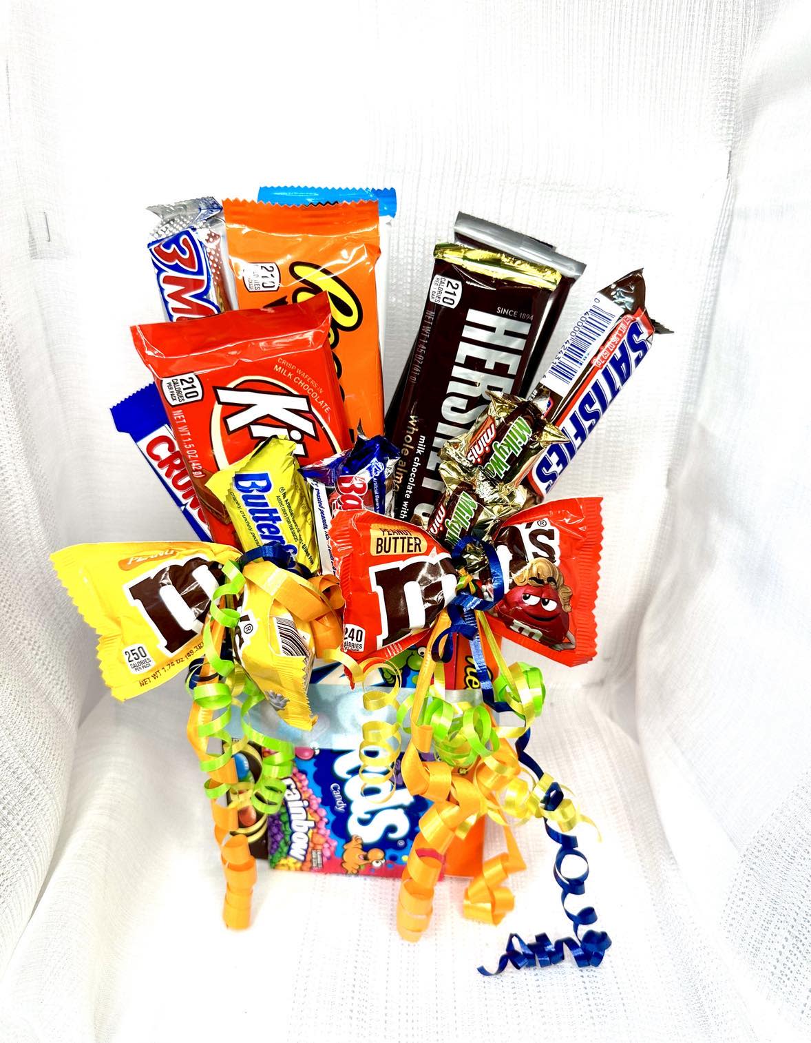 Candy bouquet with assorted chocolate bars and rainbow curling ribbons