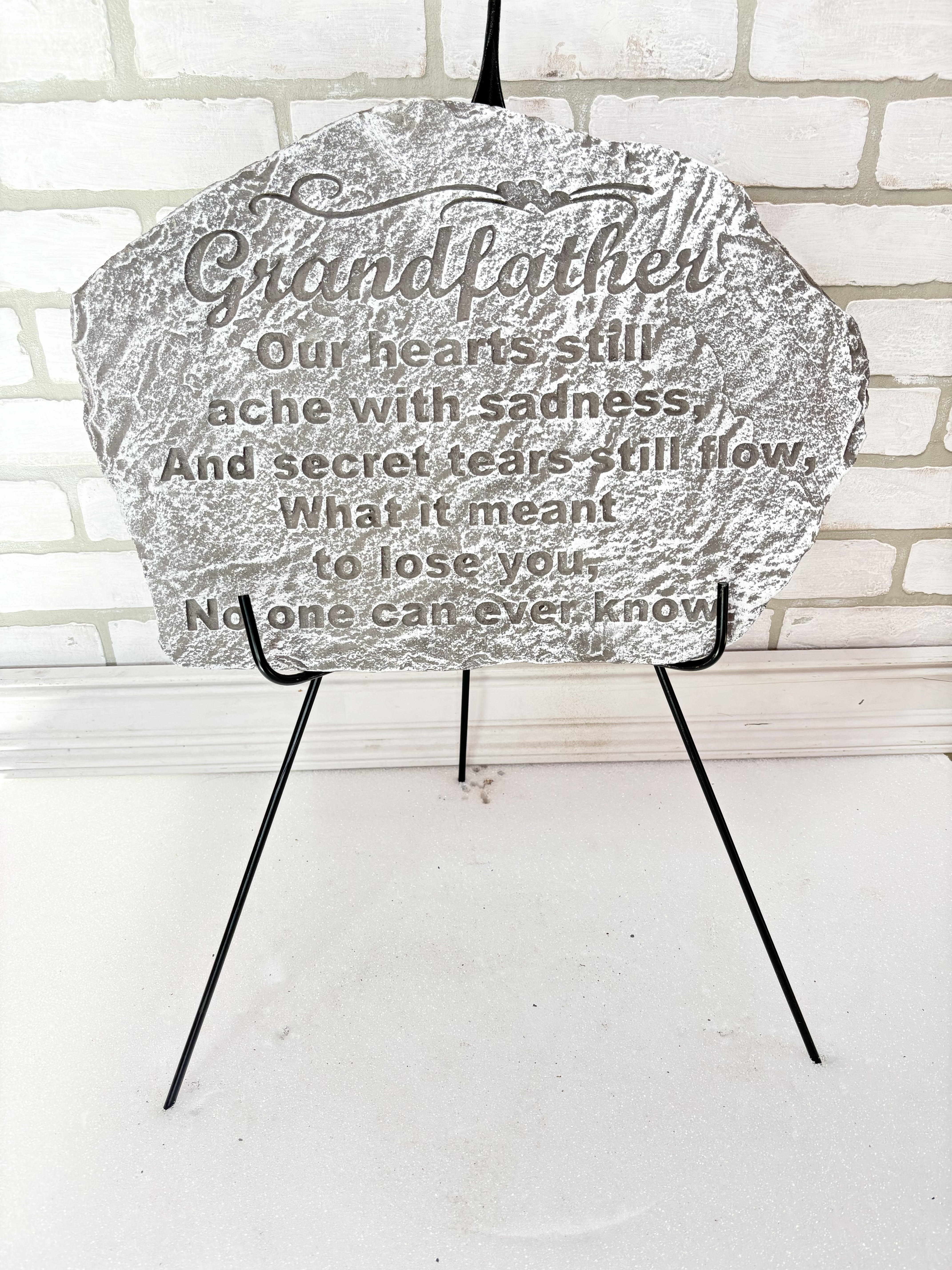 Memorial plaque on a black easel with a sympathy message