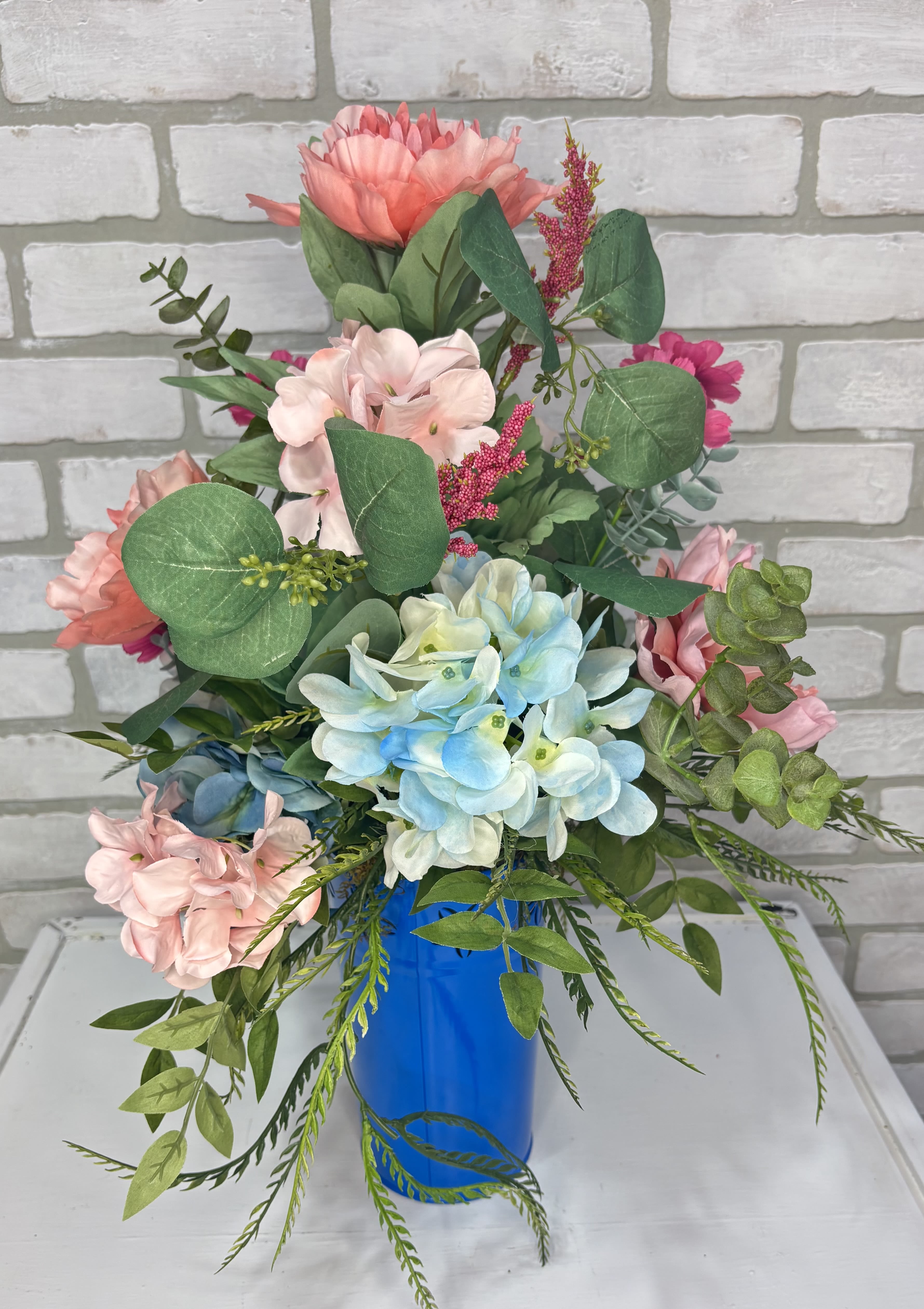 Bouquet of pastel flowers in a blue vase