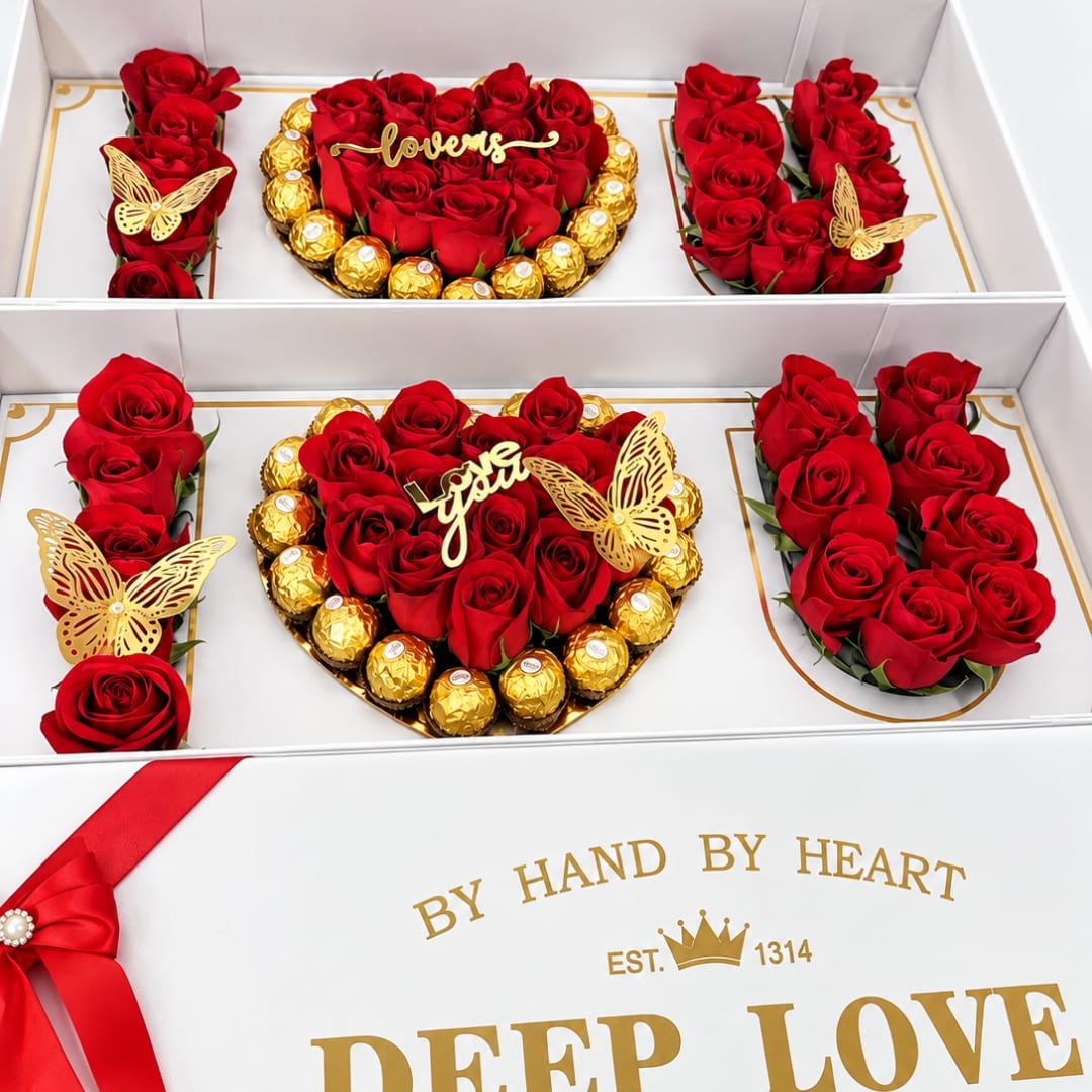 Heart-shaped rose and chocolate gift box with red roses and gold-wrapped candies