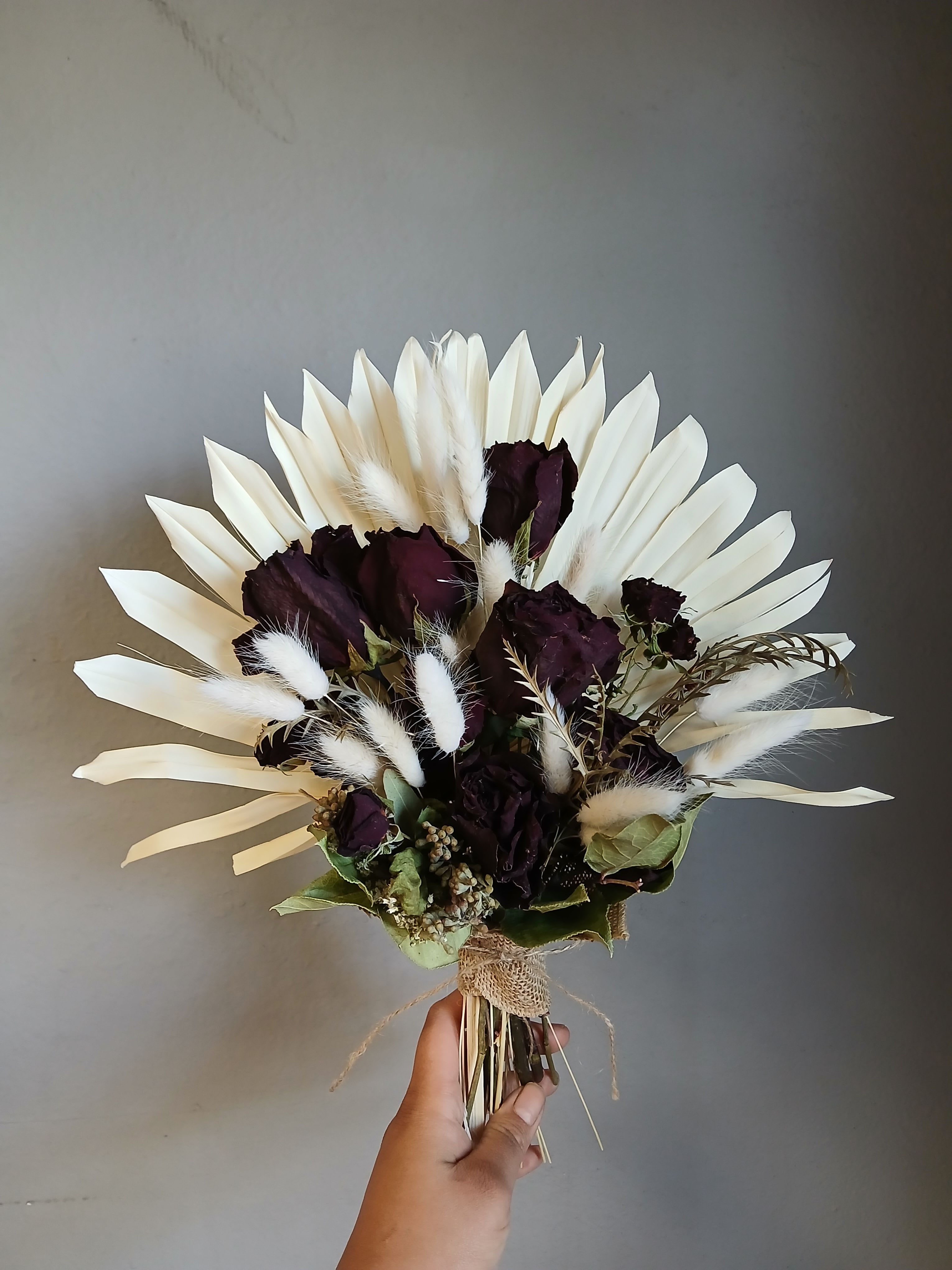 Dried Flower Bouquet #1 - Deep purple roses with pale dried petals and white grasses, wrapped in burlap and twine for a moody, rustic‑elegant bouquet-perfect for romantic or thoughtful gifting