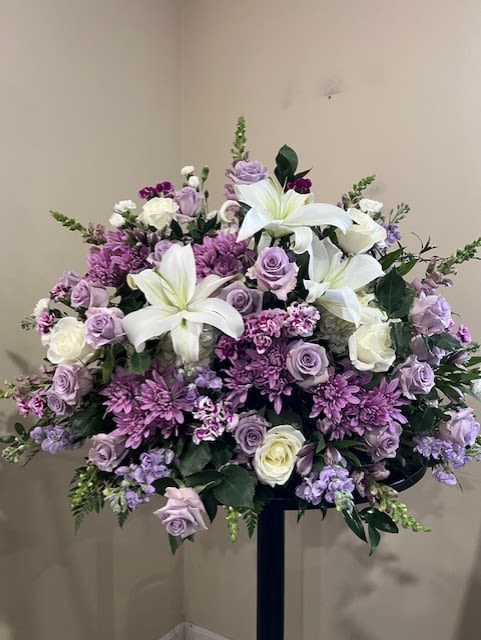 Large lavender and white floral spray with lilies and roses