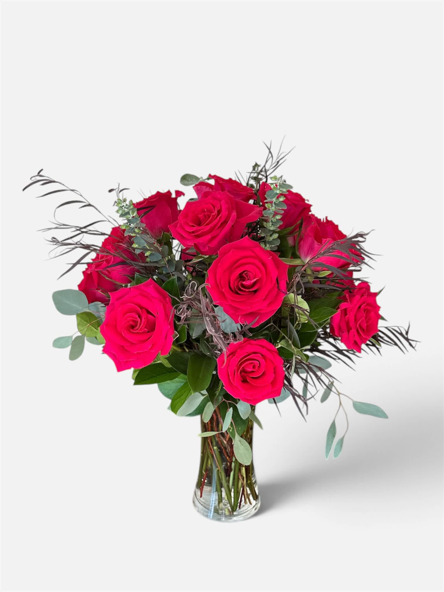 Bouquet of bright pink roses in a clear glass vase