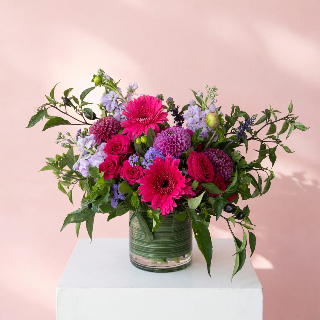 Pink and purple mixed bouquet in a glass vase