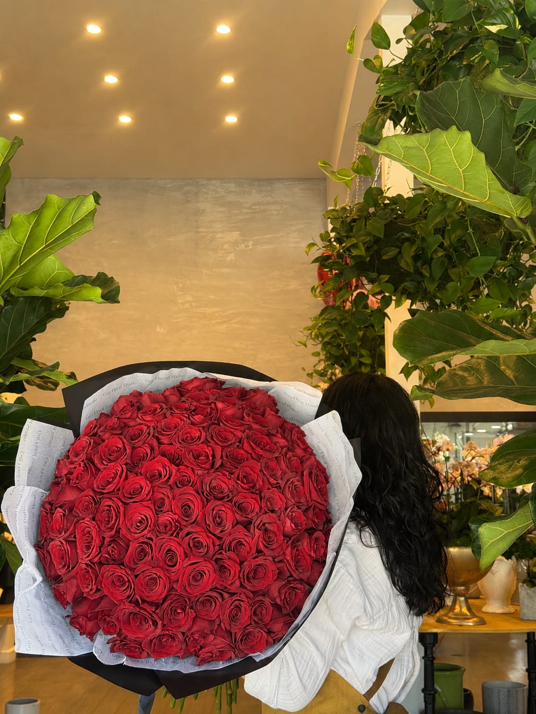 Large bouquet of red roses wrapped in black and white paper
