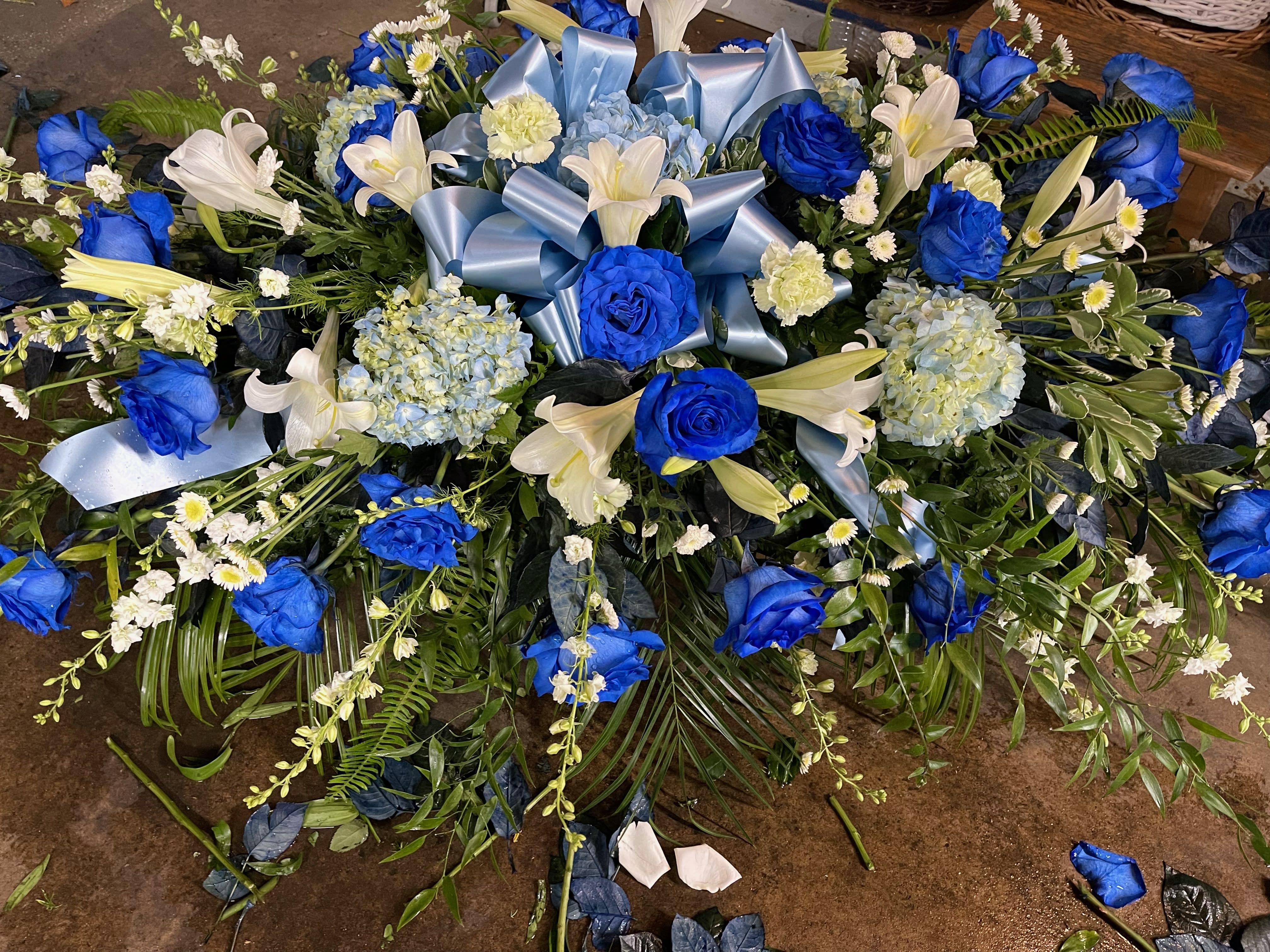 Bright Blue Casket Spray - This casket spray includes mostly blue flowers. 