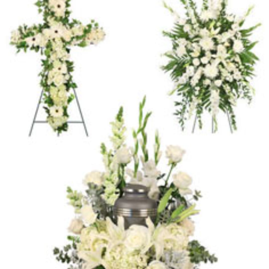 White funeral floral arrangements with a cross and standing spray
