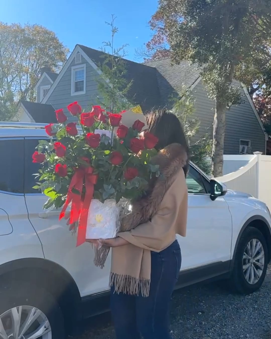 Large bouquet of red roses wrapped with a red ribbon