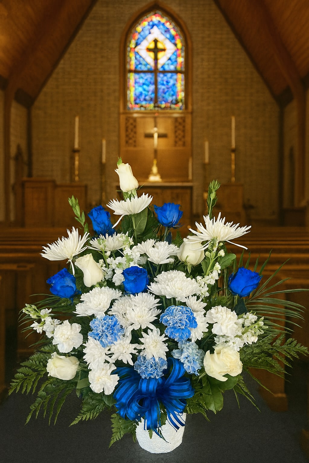 White and blue floral arrangement in a church setting
