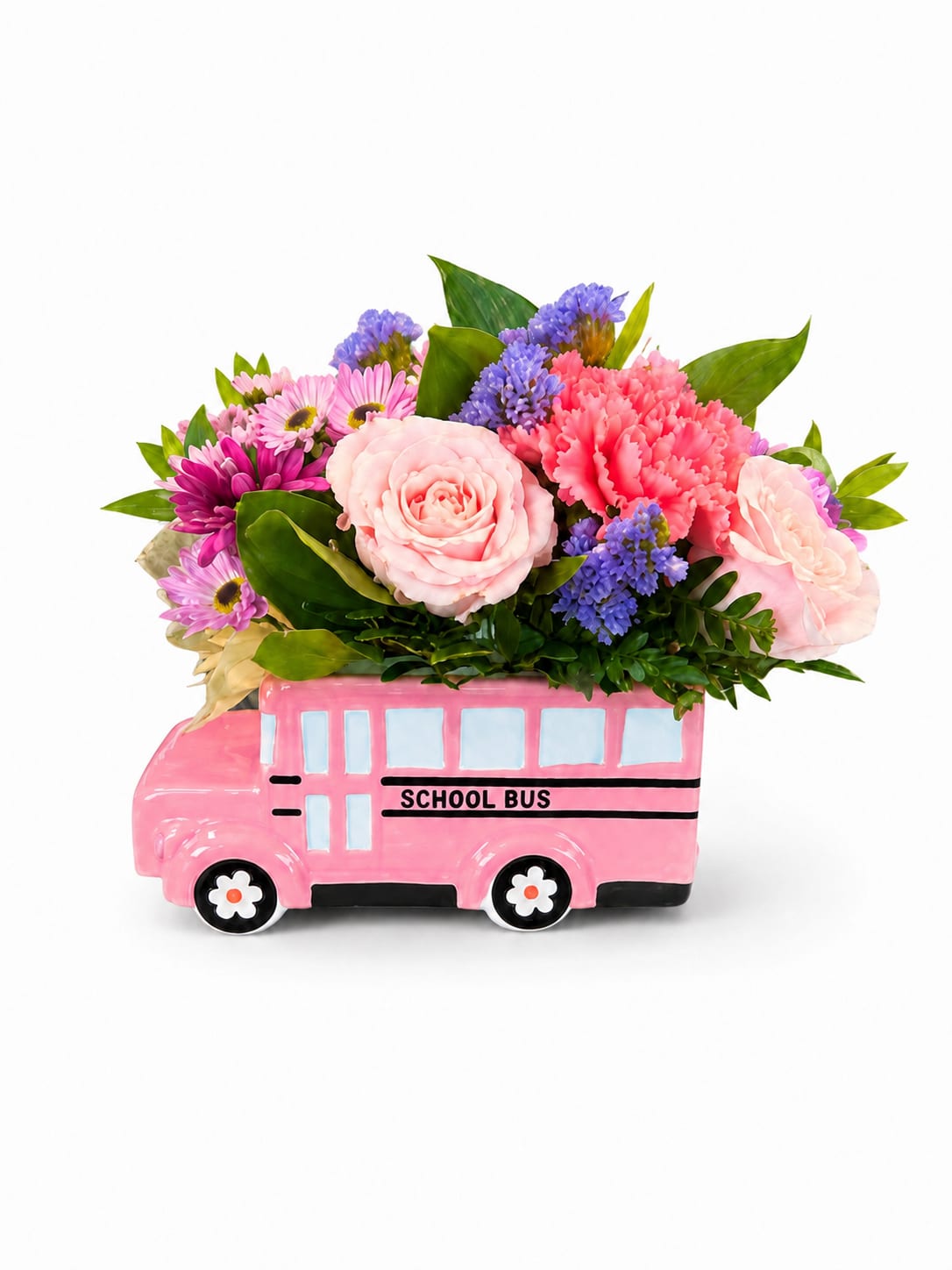 Pink floral arrangement in a pink school bus container