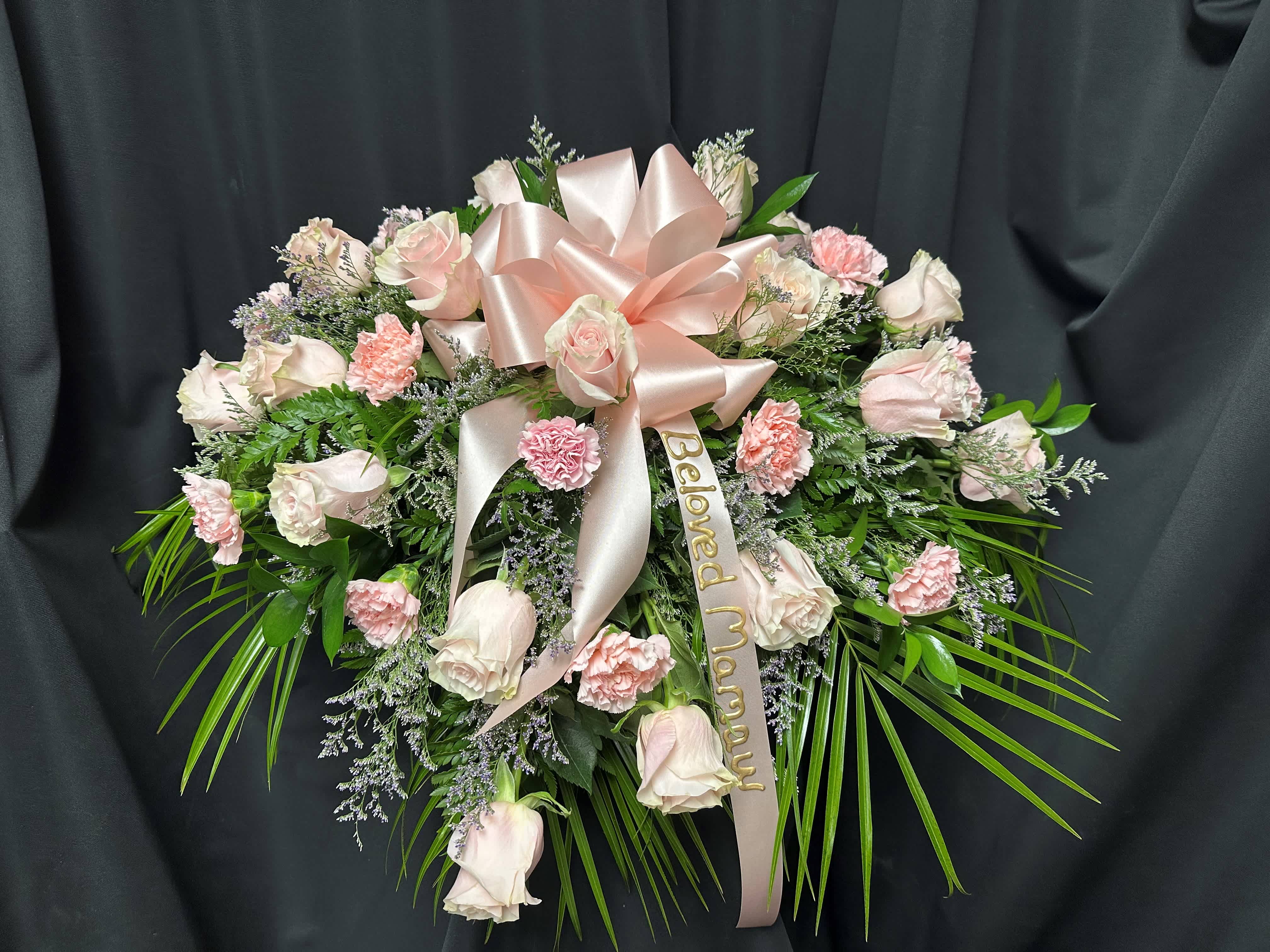 Pink and white rose spray with a satin bow and memorial ribbon