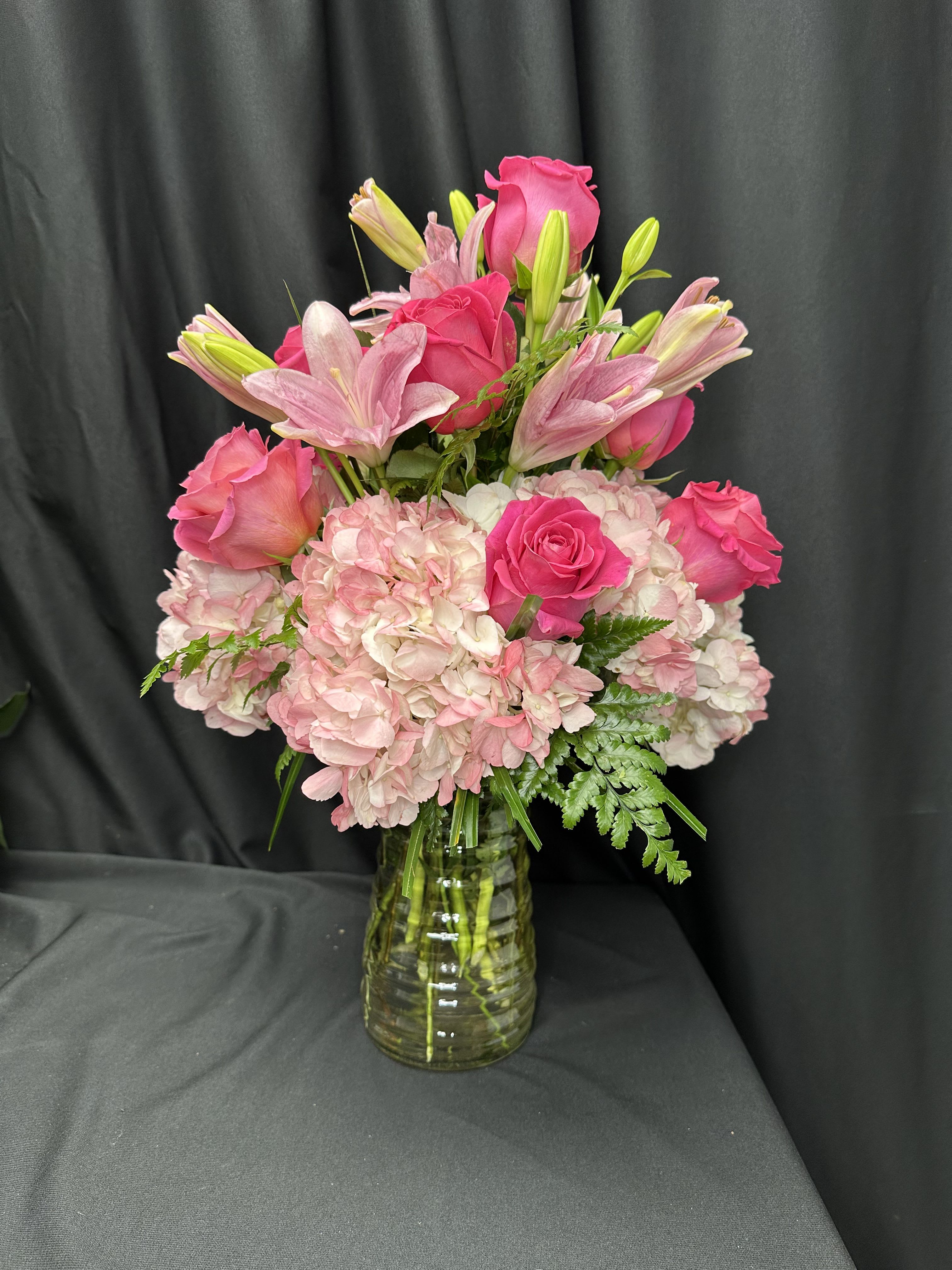 Magnificent Luxury Rose Bouquet - Indulge your special recipient with the breathtaking beauty of our Magnificent Luxury Rose Bouquet, freshly picked from select floral farms. This opulent arrangement features our finest premium long-stemmed pink roses, complemented by captivating Lilies and the soft petals of hydrangea in delicate shades of pink. Expertly arranged in a superior clear glass vase, this bouquet exudes enduring elegance and grace, making it a truly unforgettable gift.