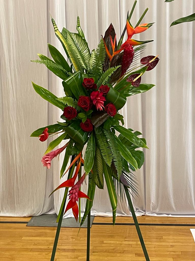 Tall tropical floral spray with red roses and orange heliconia