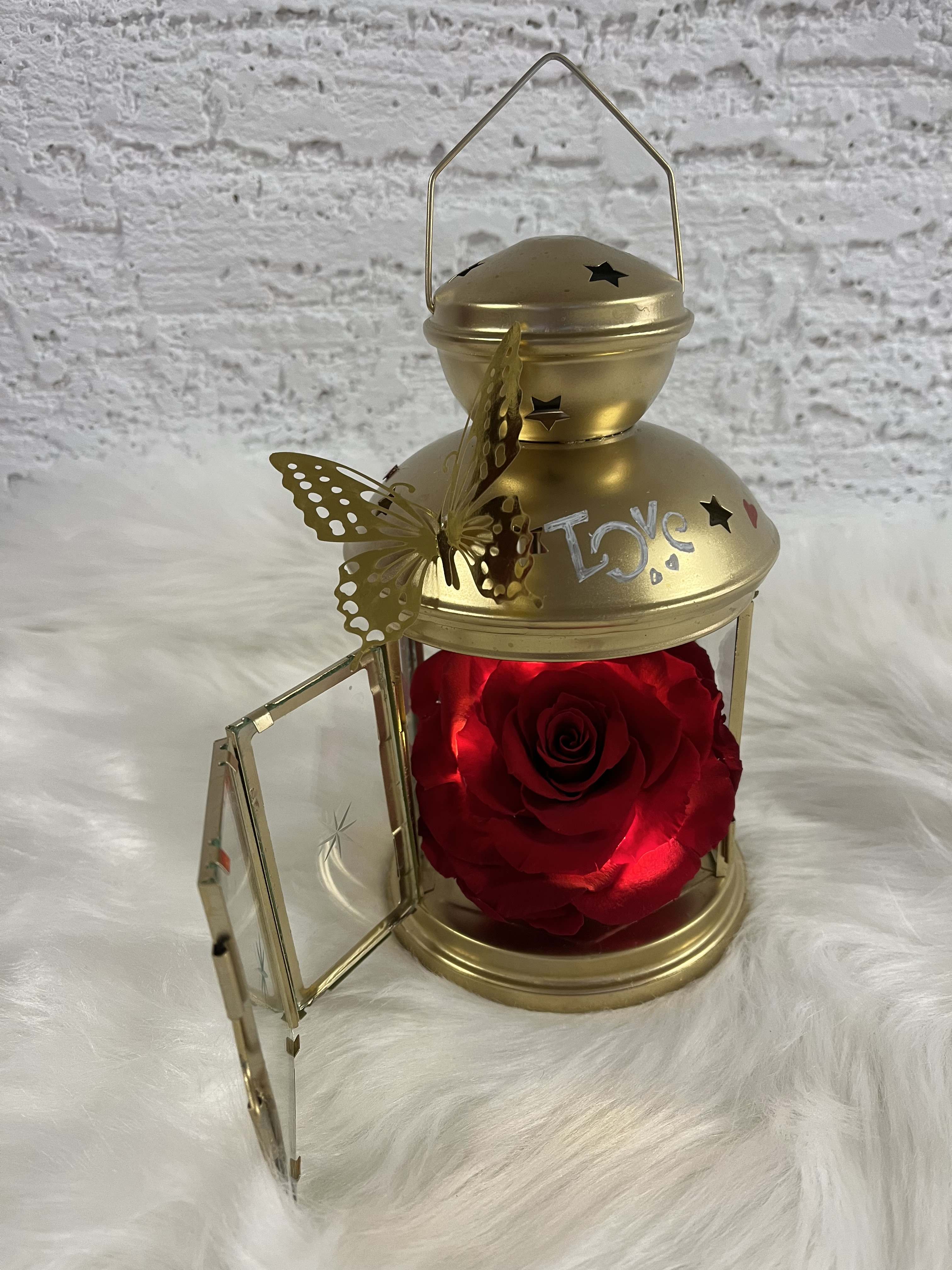 Gold lantern with a red rose inside and a butterfly decoration