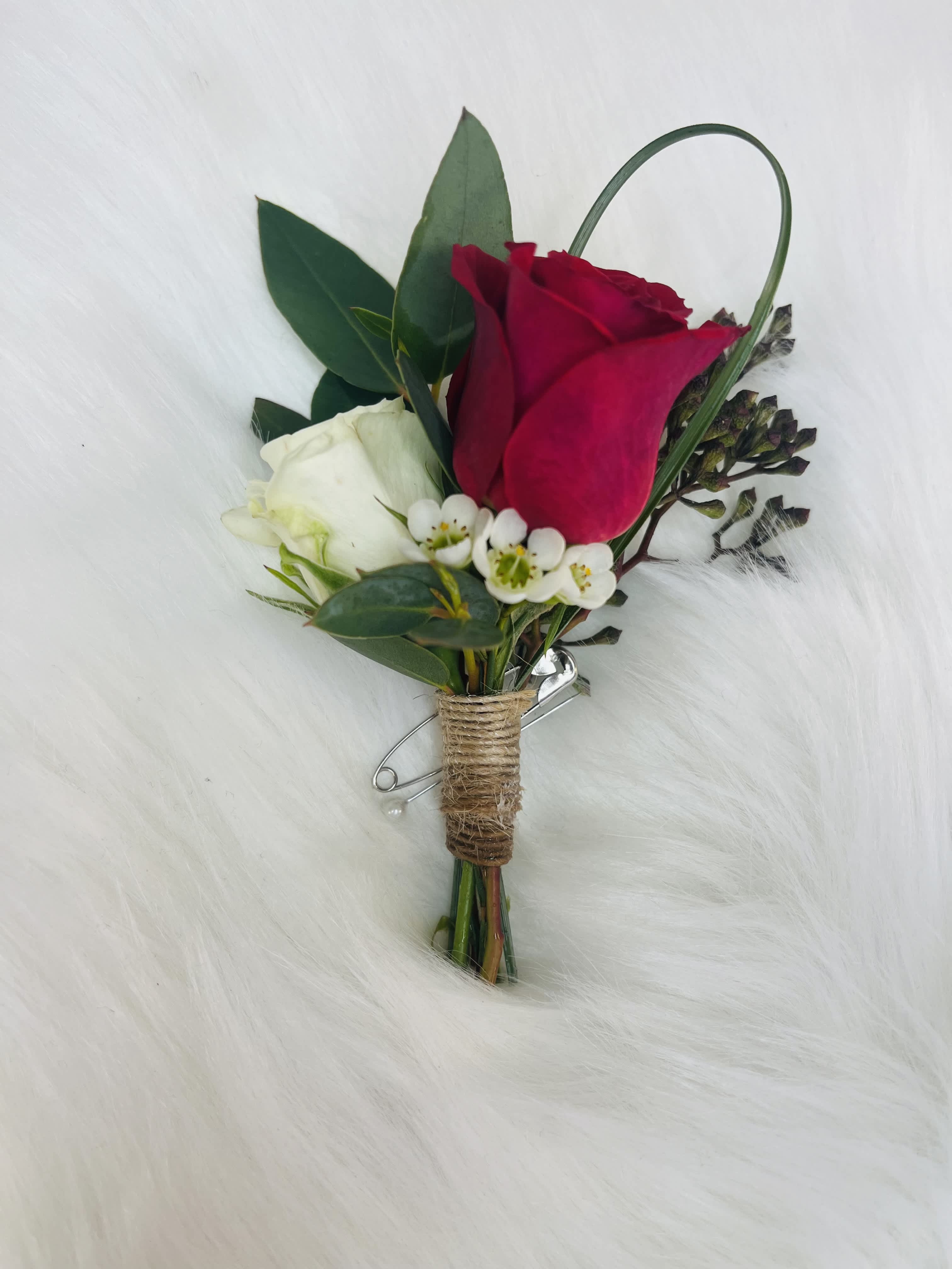 Red and white rose boutonniere with small white filler flowers