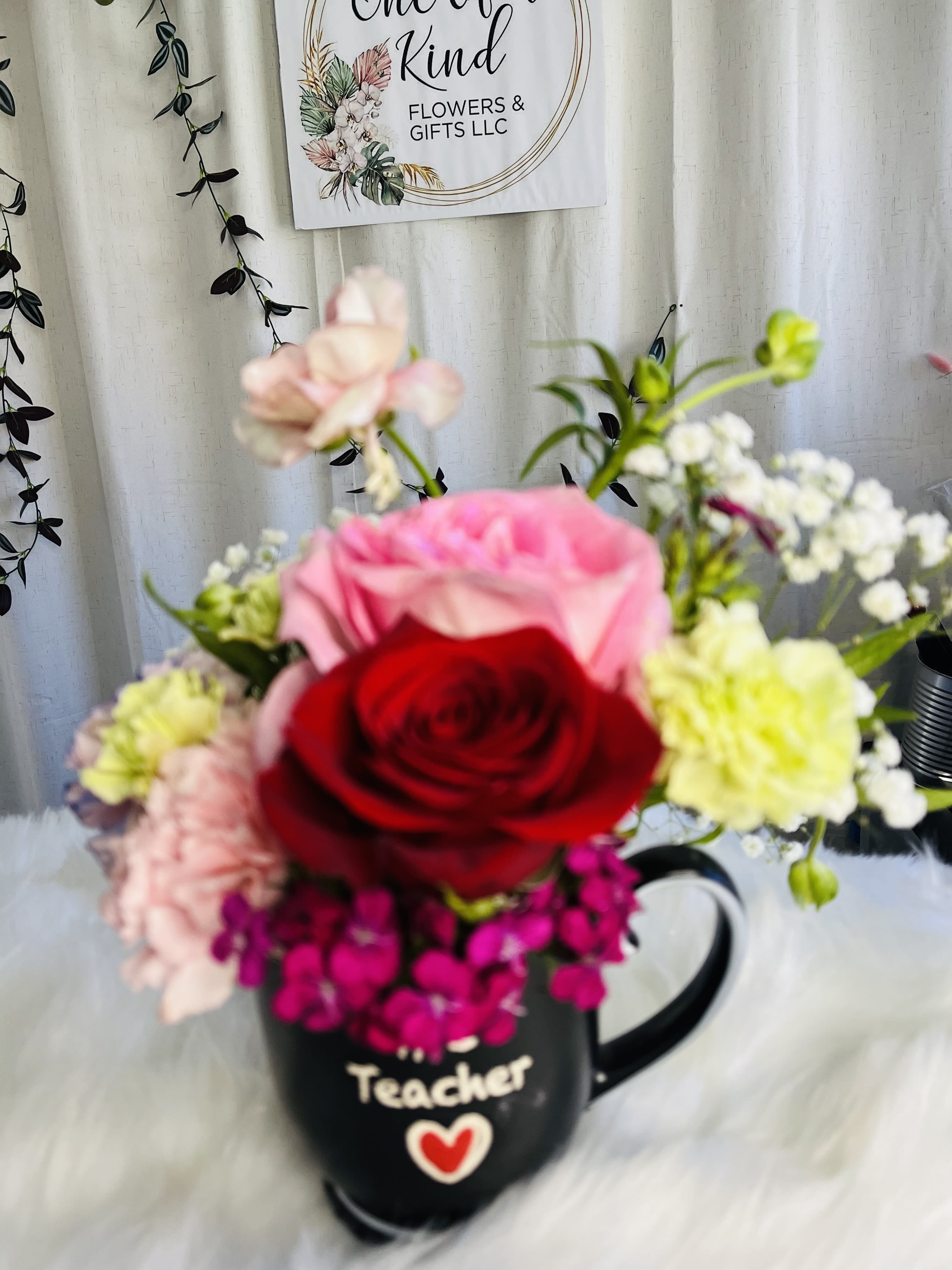 Mixed flower bouquet in a black teacher mug