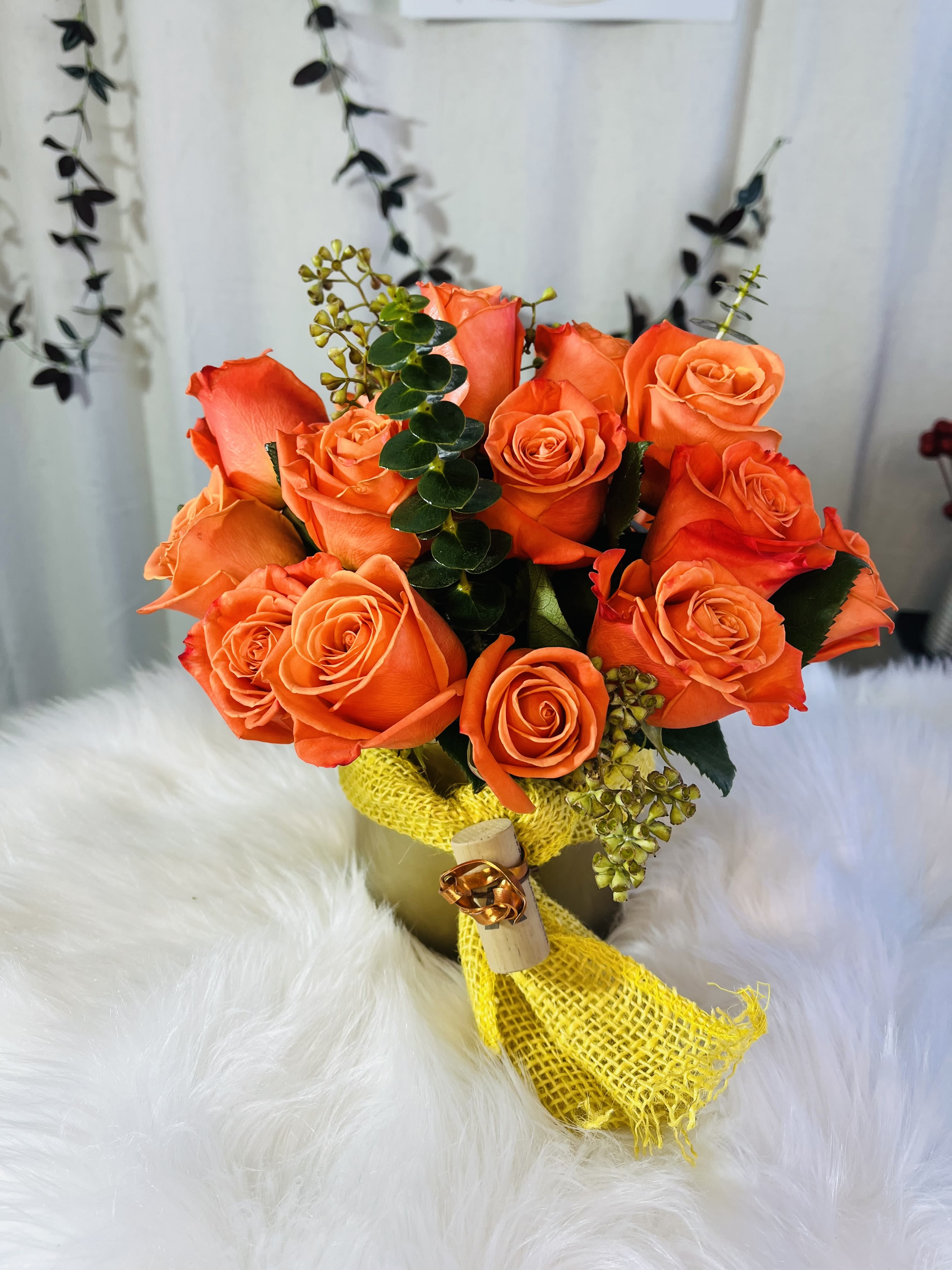 Orange rose bouquet wrapped with yellow mesh ribbon