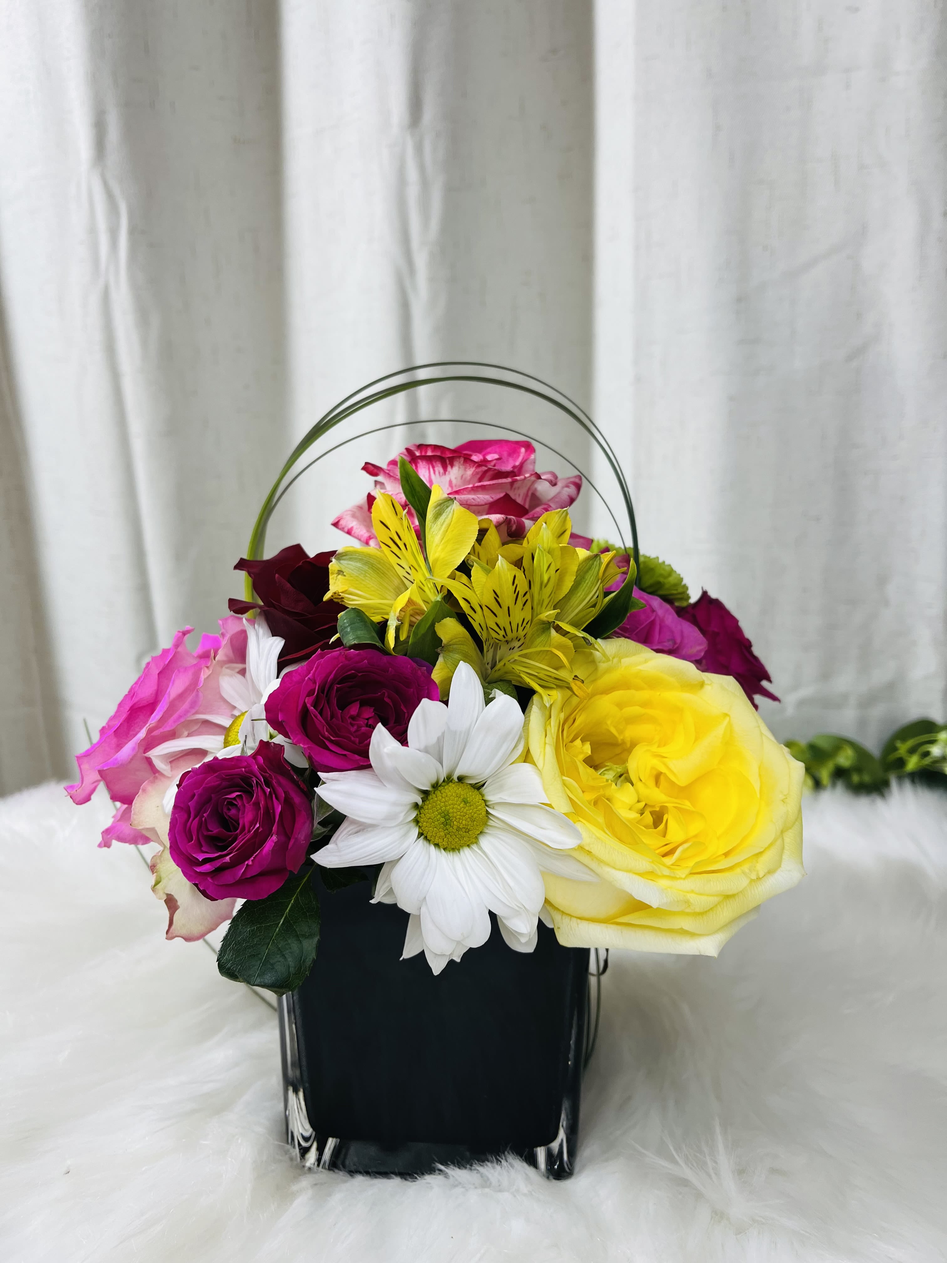 Colorful flower basket with roses, daisies, and yellow alstroemeria