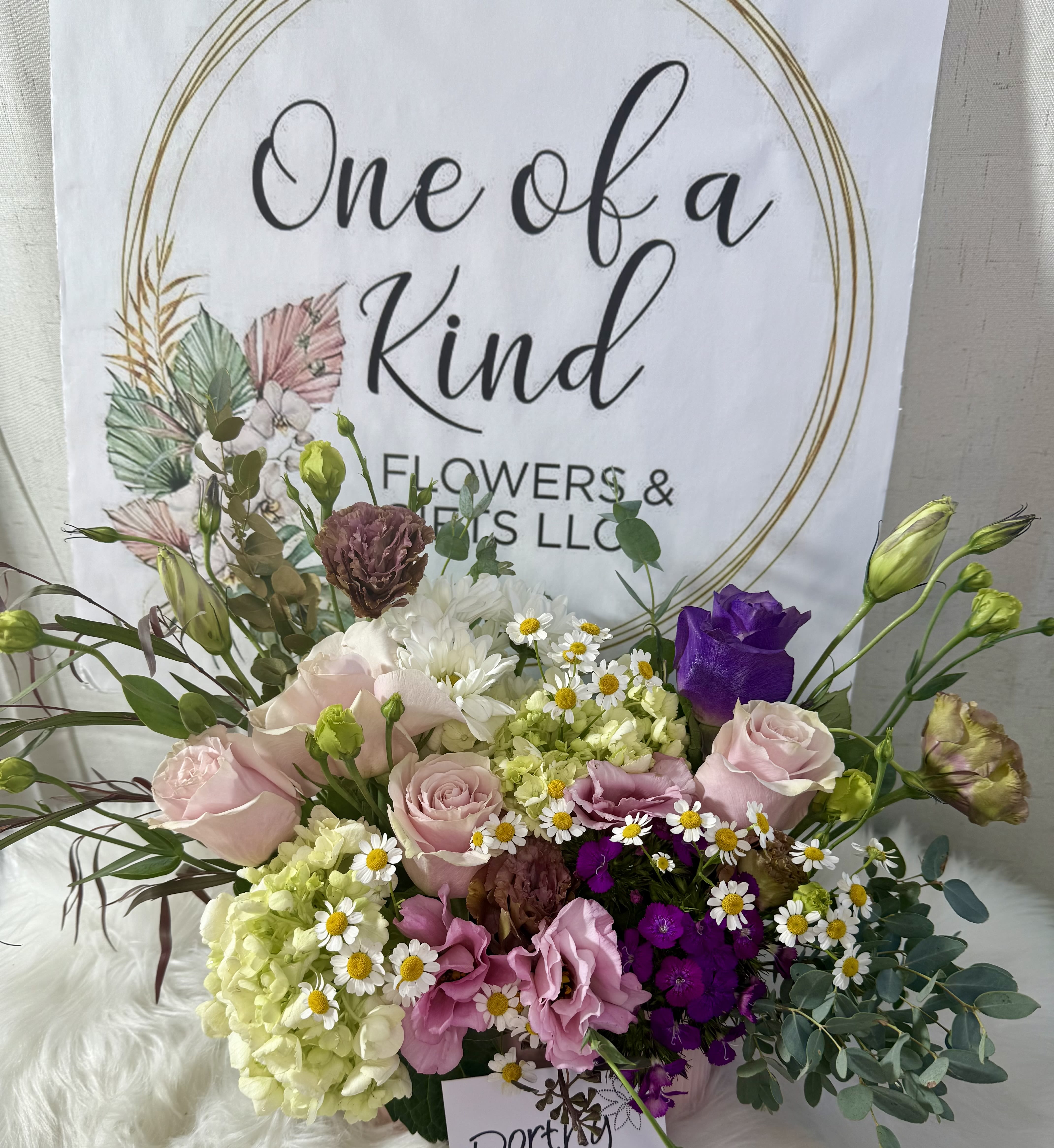Mixed bouquet of pink, purple, white, and green flowers