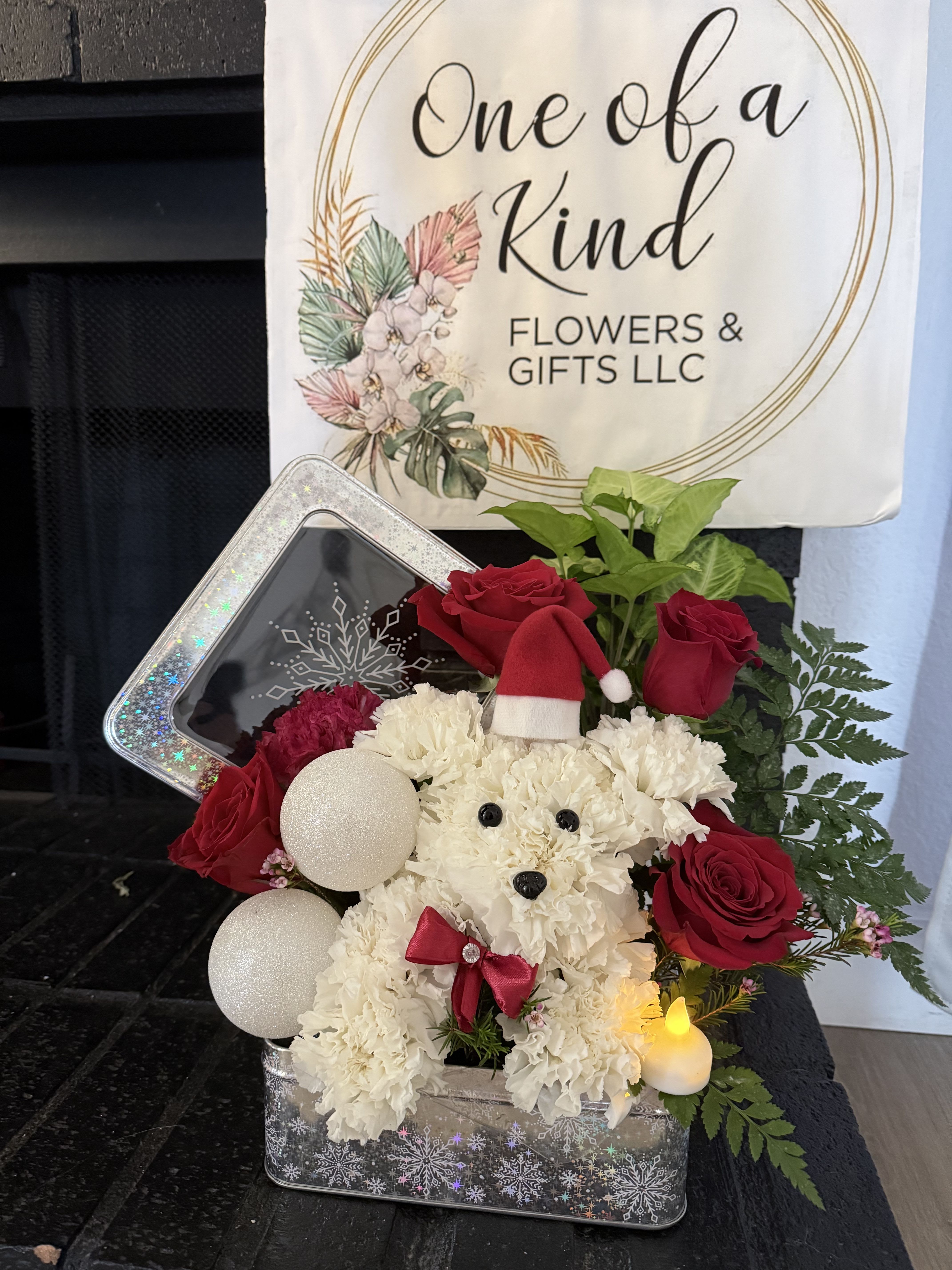 White teddy bear floral arrangement with red roses and ornaments in a tin box