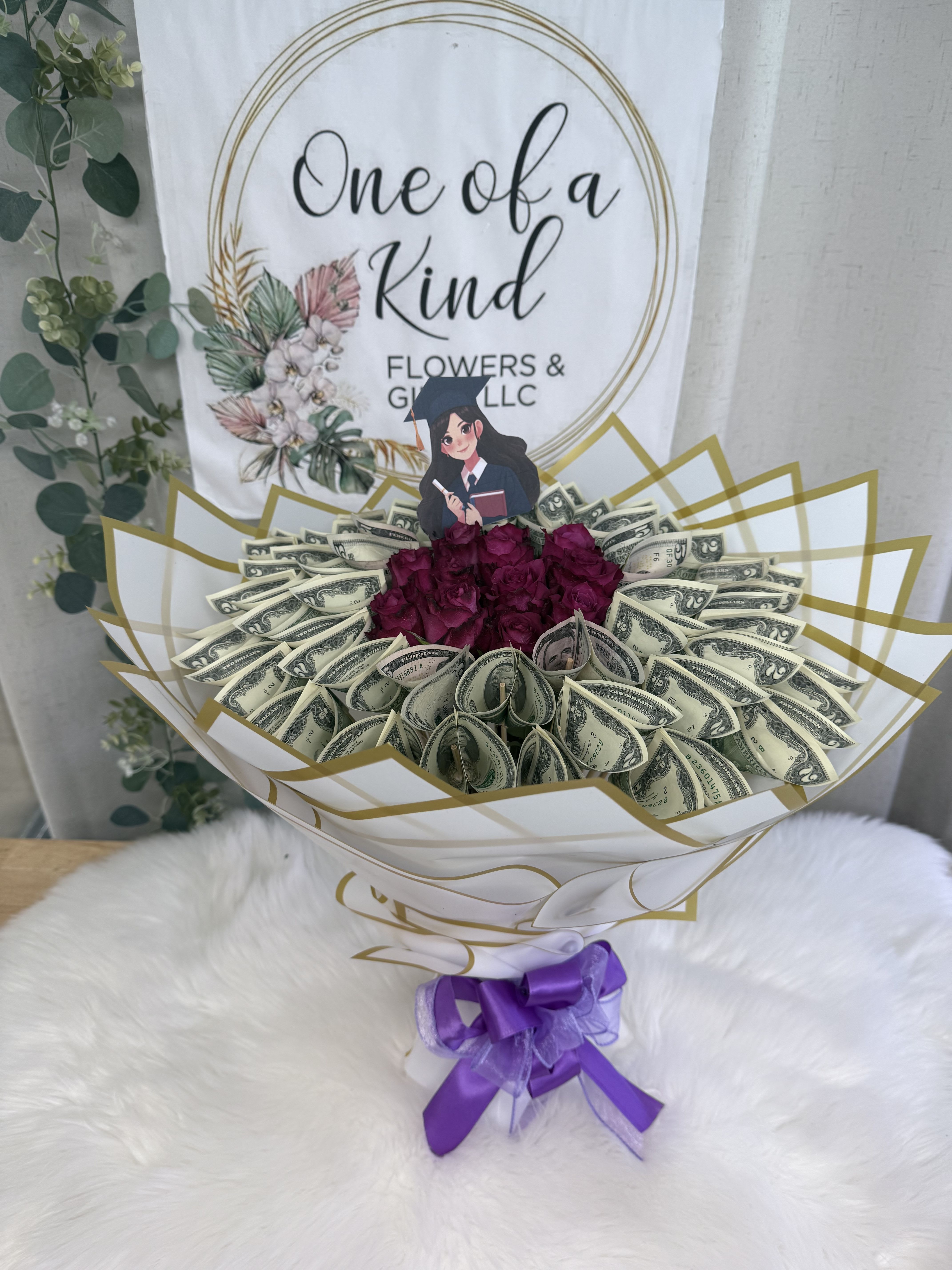 Royal Bloom Money Bouquet - A luxurious bouquet made with a dozen real roses and real $1 or $2 bills, beautifully arranged for graduations, birthdays, anniversaries, or any special celebration. This design includes $100 in cash, and we can customize it with any amount you would like to gift. You can also choose your preferred rose color to make it extra special. Elegant, unique, and truly one of a kind!