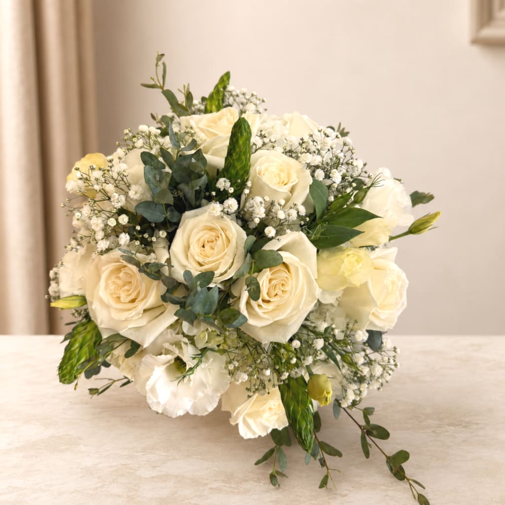 Cream rose bridal bouquet with baby's breath and greenery