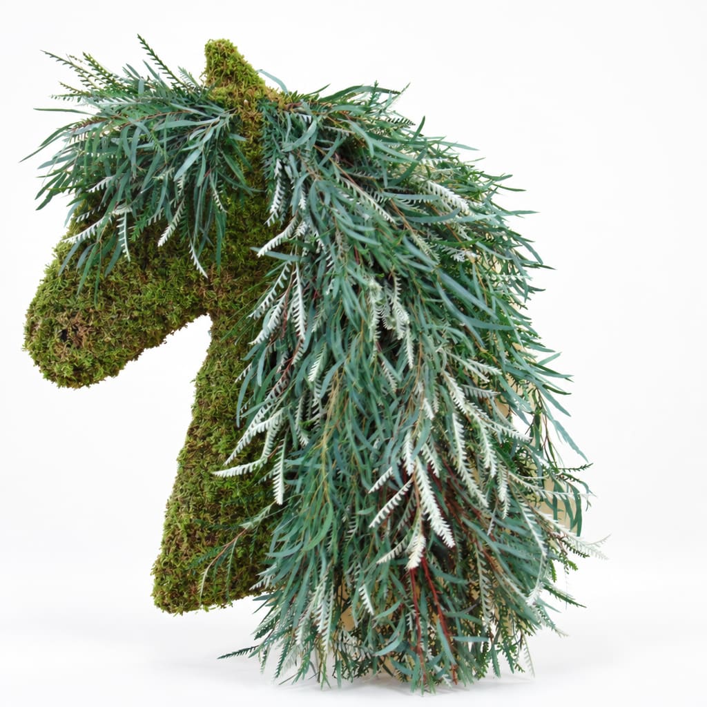 Moss-covered horse sculpture draped with cascading greenery