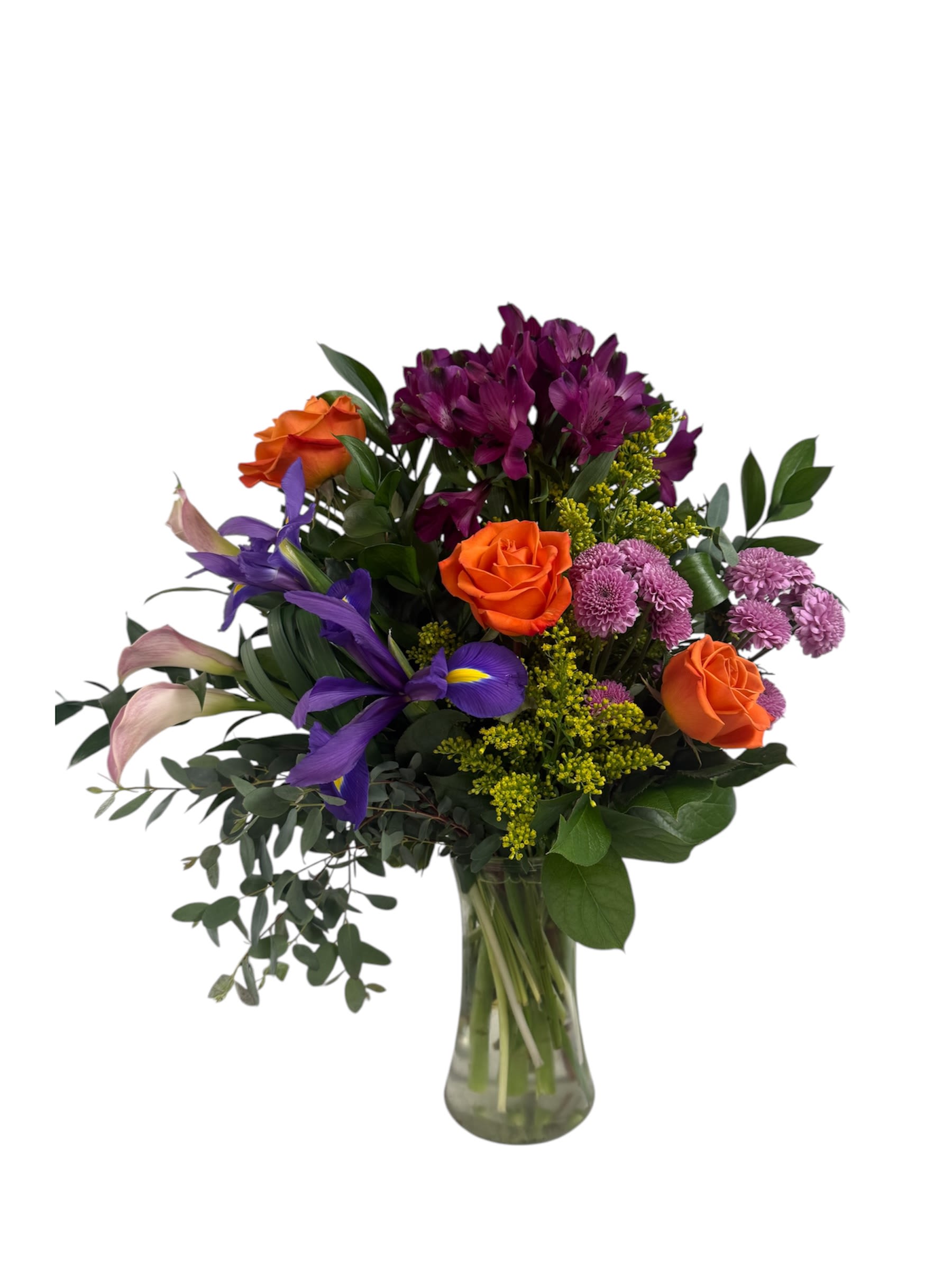 Tropical Breeze - A vibrant mix of purple alstroemeria, orange roses, yellow solidago, royal blue iris and pink calla lilies accented with eucalyptus and ruscus. This arrangements is designed and delivered in a clear glass gathering vase.