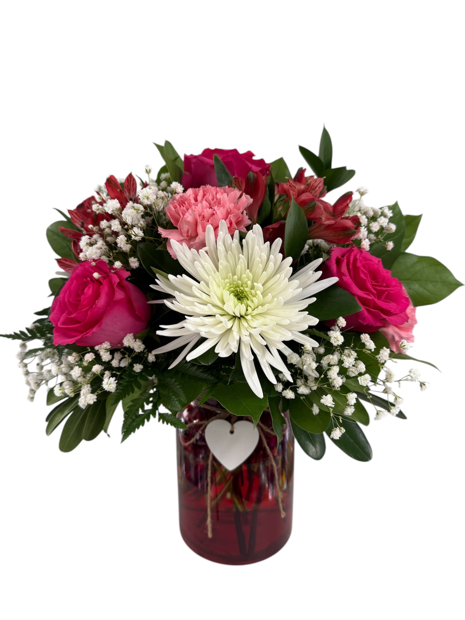 Pink and white flowers arranged in a red glass vase