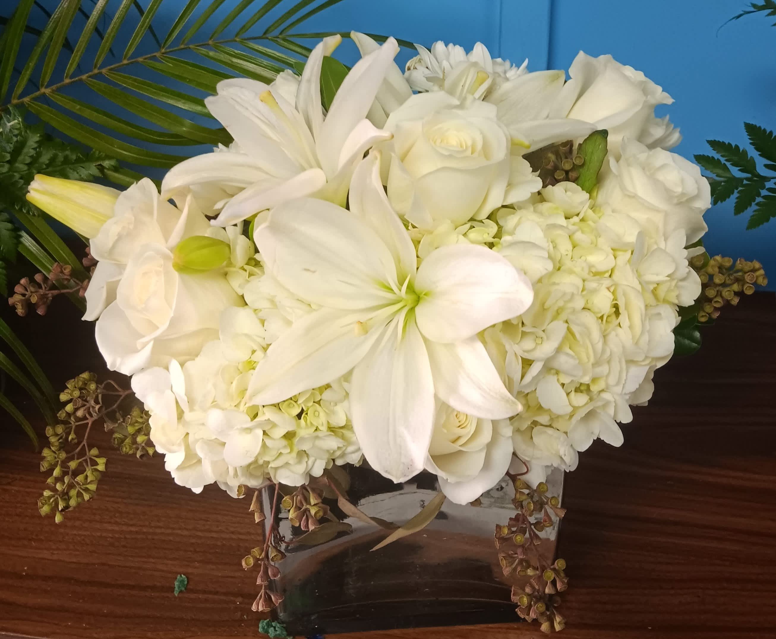White floral arrangement in a clear glass vase