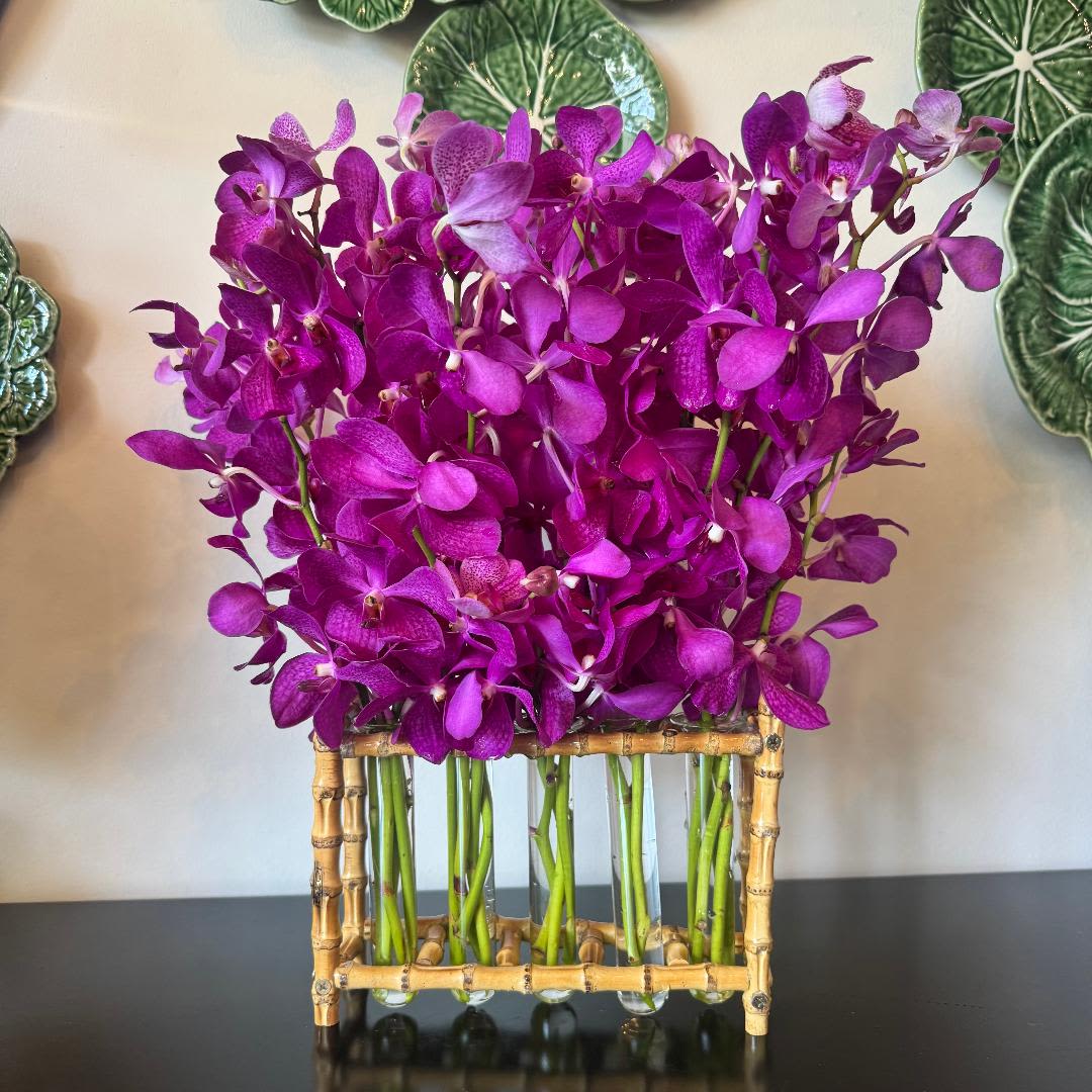 Bamboo Beauty - An elegant, striking design featuring tropical orchids arranged in a sleek bamboo and glass vase. Minimal yet luxurious, this piece brings sculptural lines and serene, spa-like freshness—perfect for modern interiors, thank-yous, or a sophisticated just-because.  Please note: These exquisite orchids are not always available. If needed, we’ll substitute a comparable orchid variety to maintain the same refined look and feel.  Freshness Guarantee: We stand behind our quality. Your flowers are guaranteed to look fresh and beautiful for 3–5 days from delivery.  To help them last:  •Top off the vase with clean water daily.  •Keep arrangements away from direct sun, heat, and drafts.  •Trim stems slightly after a couple of days if possible.