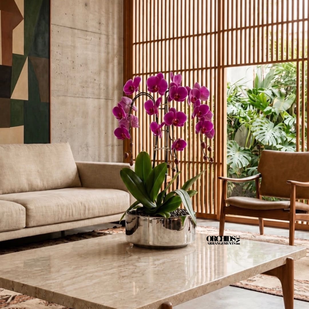 Potted purple orchid arrangement in a metallic planter on a coffee table