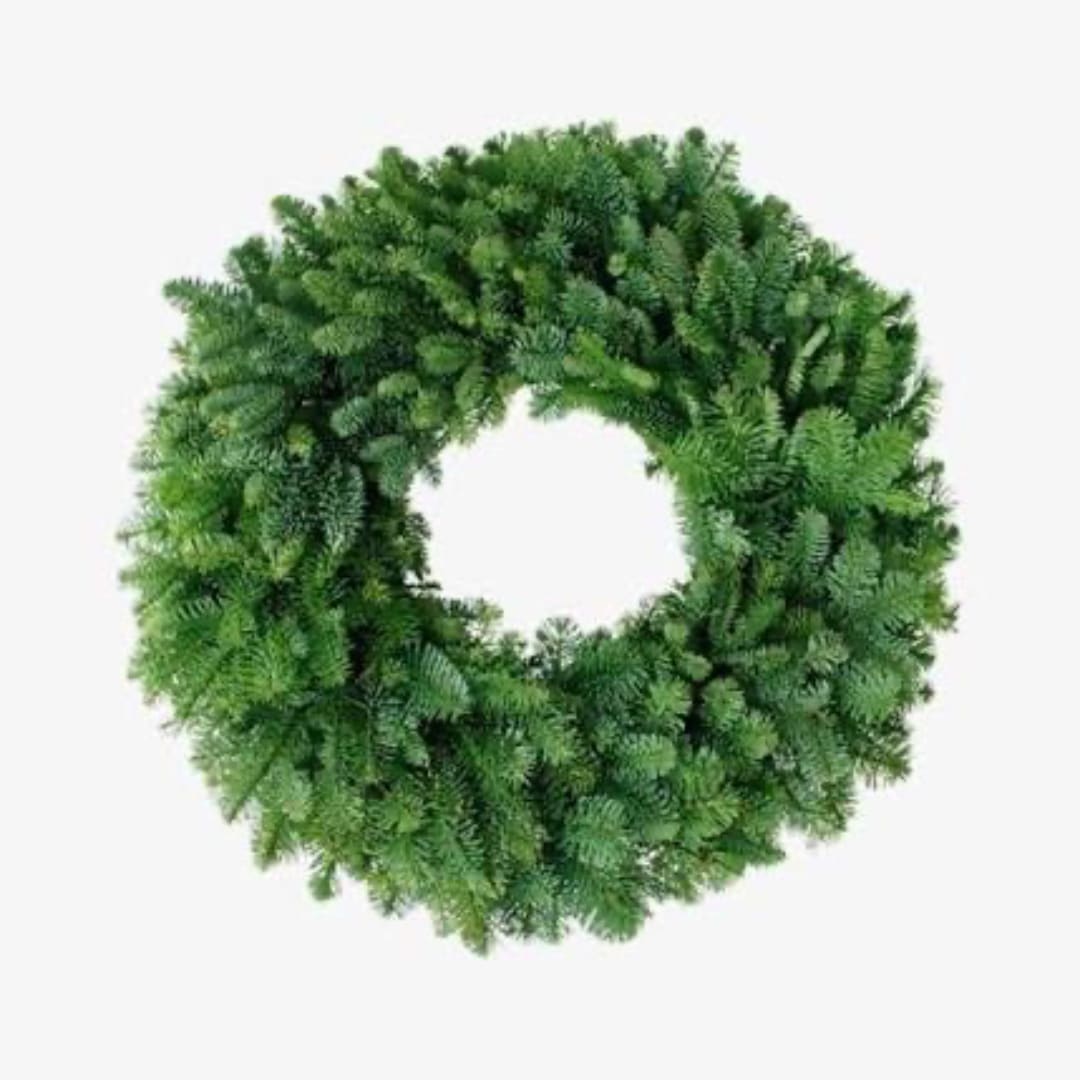 Green wreath made of dense evergreen foliage on a white background