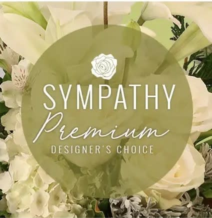 White sympathy floral arrangement with lilies and roses