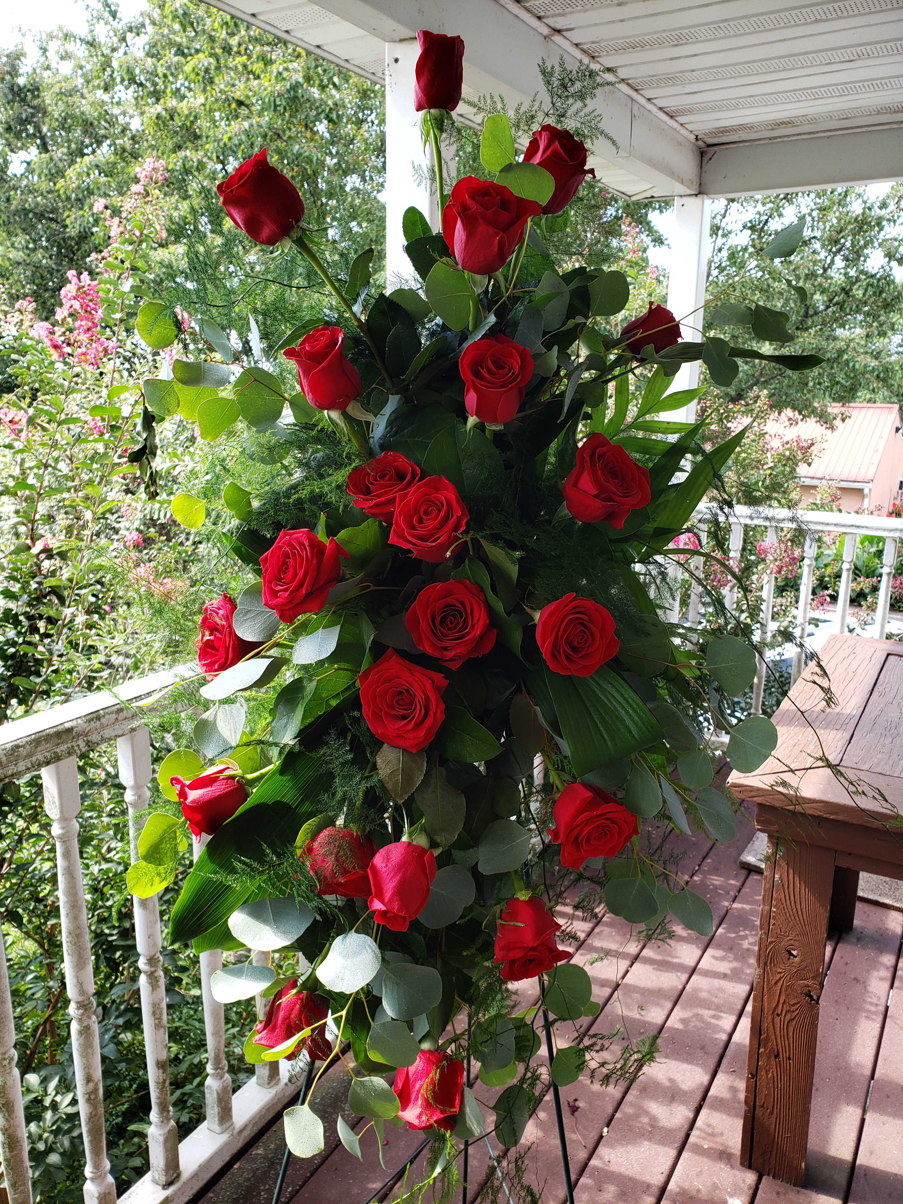 Tall bouquet of red roses with eucalyptus greenery