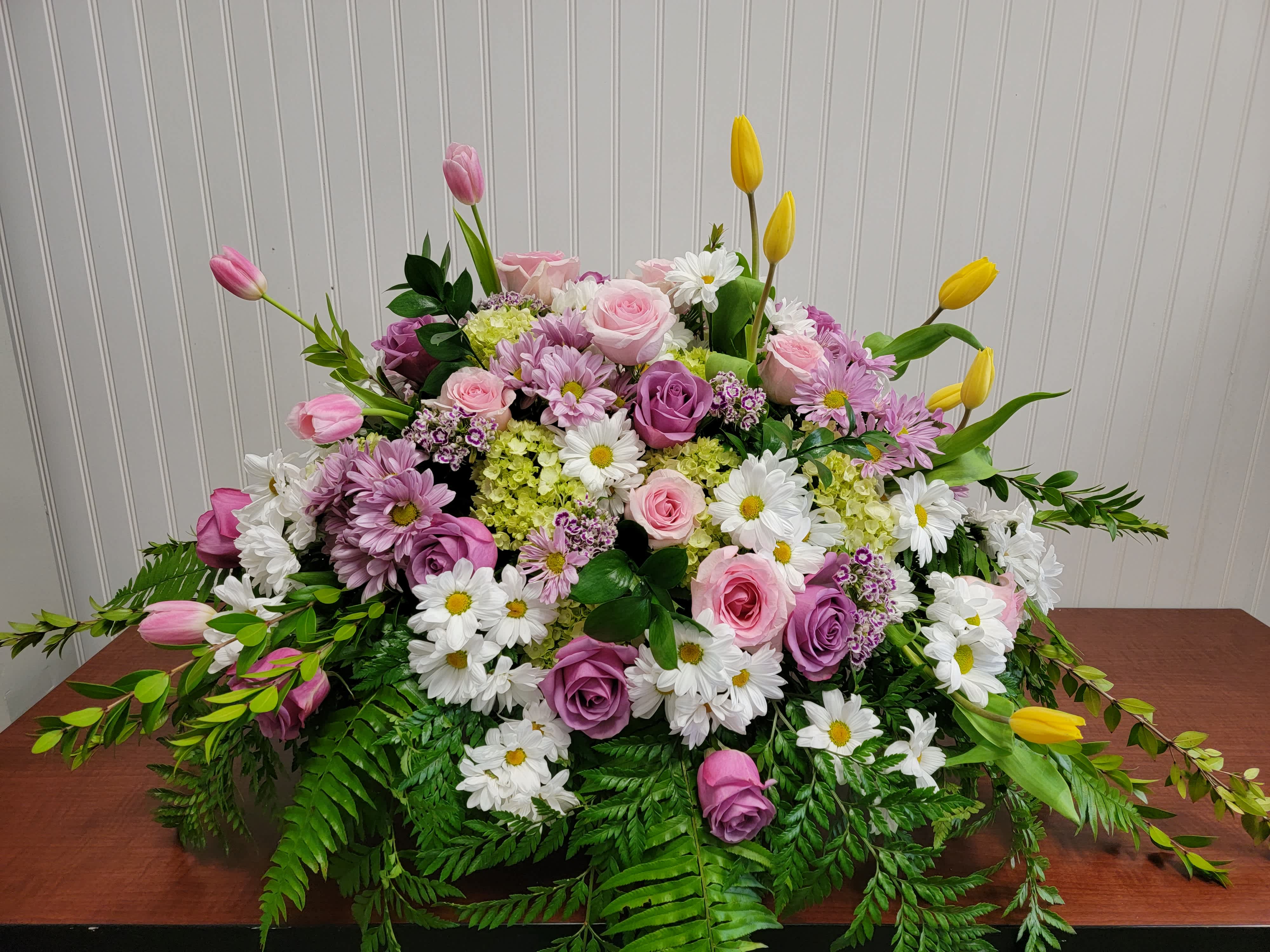 Large mixed bouquet of pink and purple roses with white daisies and yellow tulips