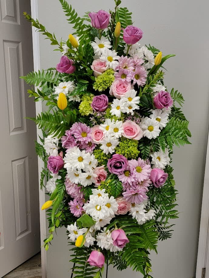 Tall standing floral spray with pink roses, white daisies, and yellow tulips