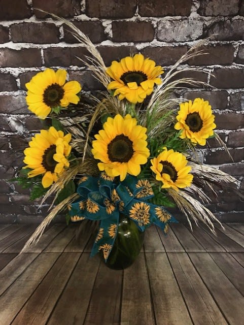 Fields of Sunshine - A half Dozen Sunflowers in glass vase filled with greenery and pampas grass. A sunny bouquet for anyone. Approx.  15" W x 18" H