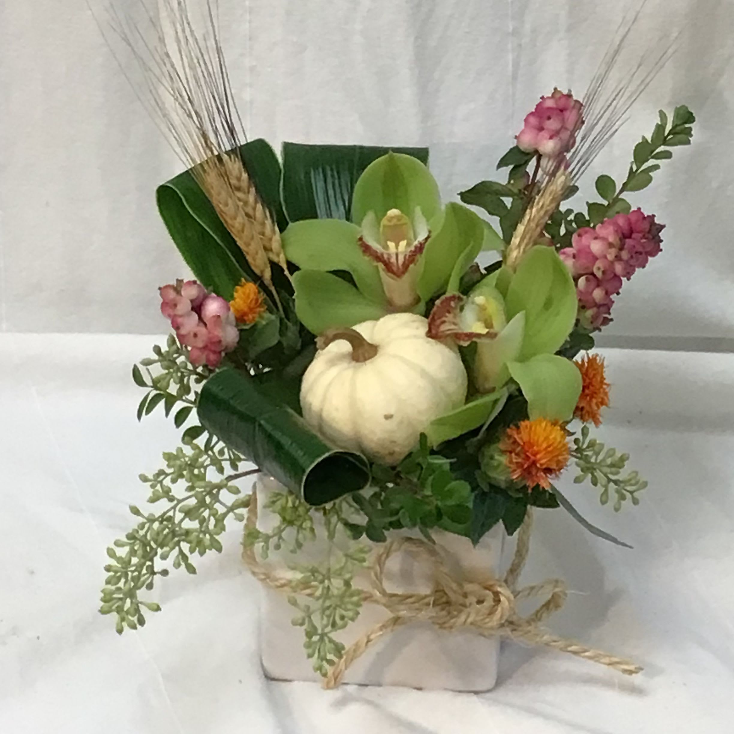 My ‘lil Pumpkin Patch  - A cute little arrangement depicting a miniature pumpkin patch. Perfect for a thinking of you or a hostess gift. The arrangment includes a mini pumpkin and cymbidium orchids  all delightfully arranged in a keepsake container.It is approximately 10” x 10”