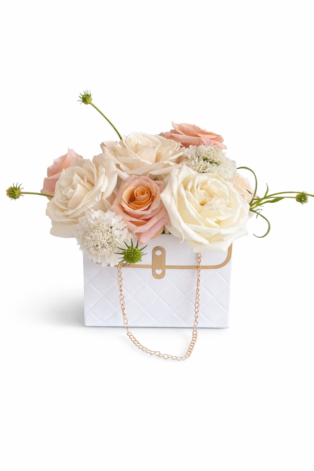 Cream and blush roses arranged in a white handbag-style box