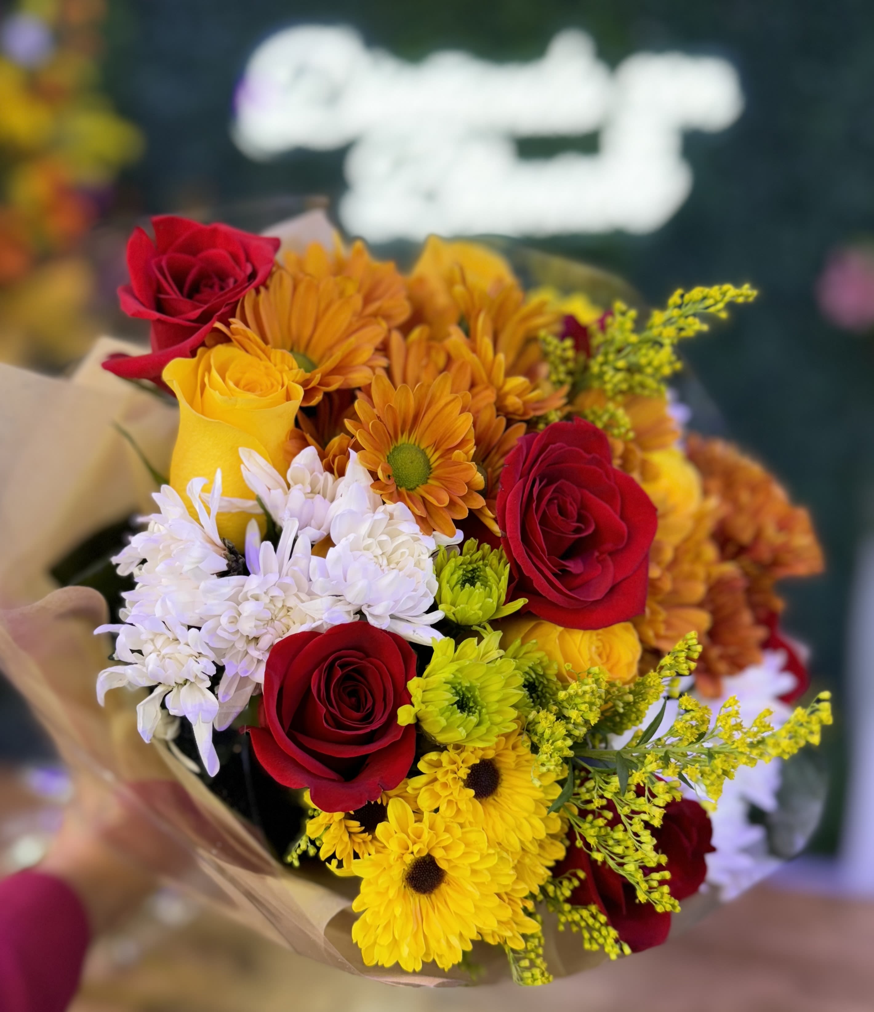 Fall Breeze  - "A stunning blend of red, yellow roses and daisies in autumn hues of orange, yellow, and white, evoking the crisp, refreshing breeze of fall. A perfect way to celebrate the season." 