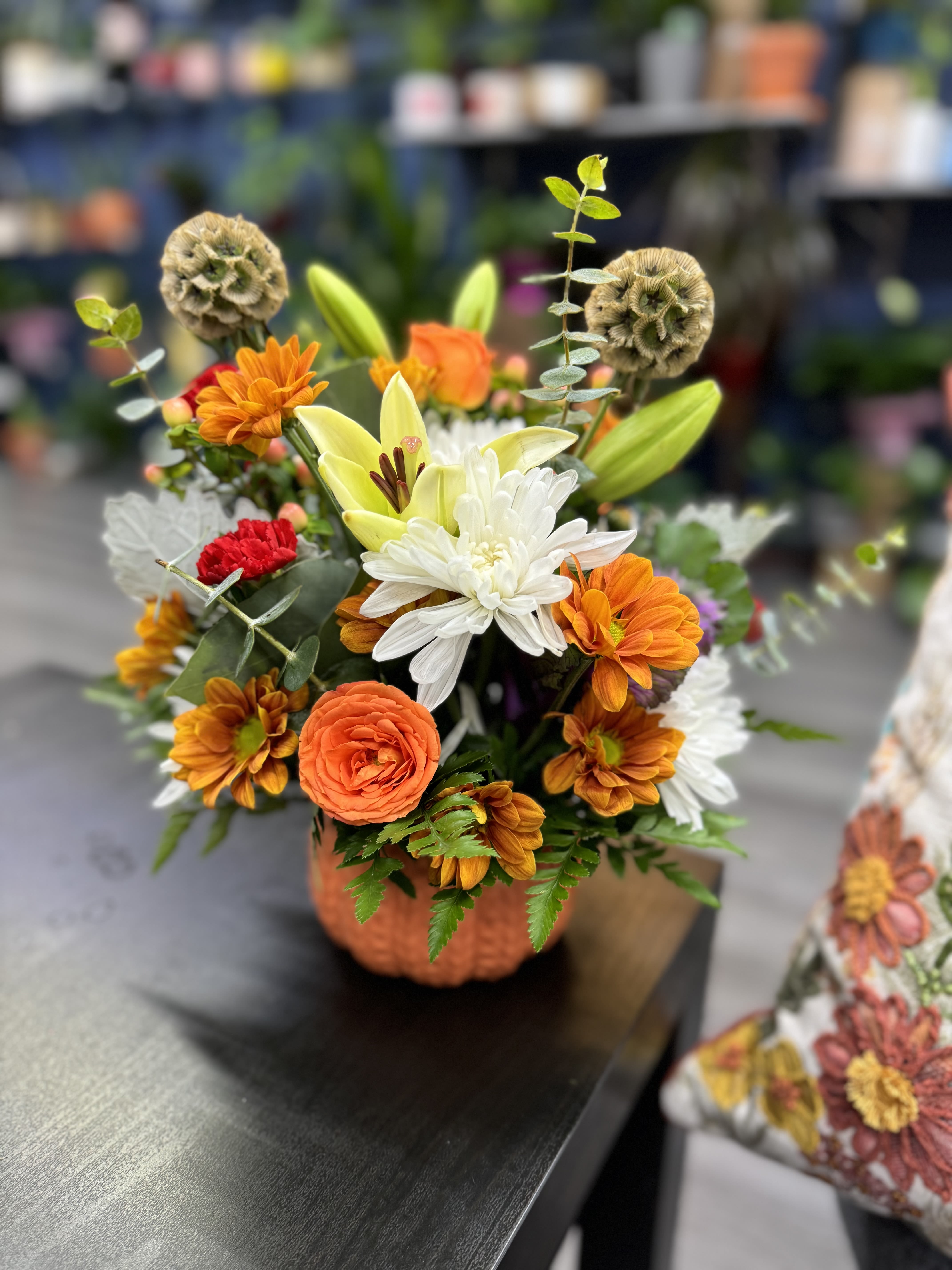 Pumpkin Blooms - “A unique arrangement set in a natural pumpkin, featuring vibrant, handpicked flowers that reflect the beauty of the season. This charming floral display is perfect for a fall centerpiece, adding a festive touch to any room and making every moment feel like autumn.” 12”hx10”w