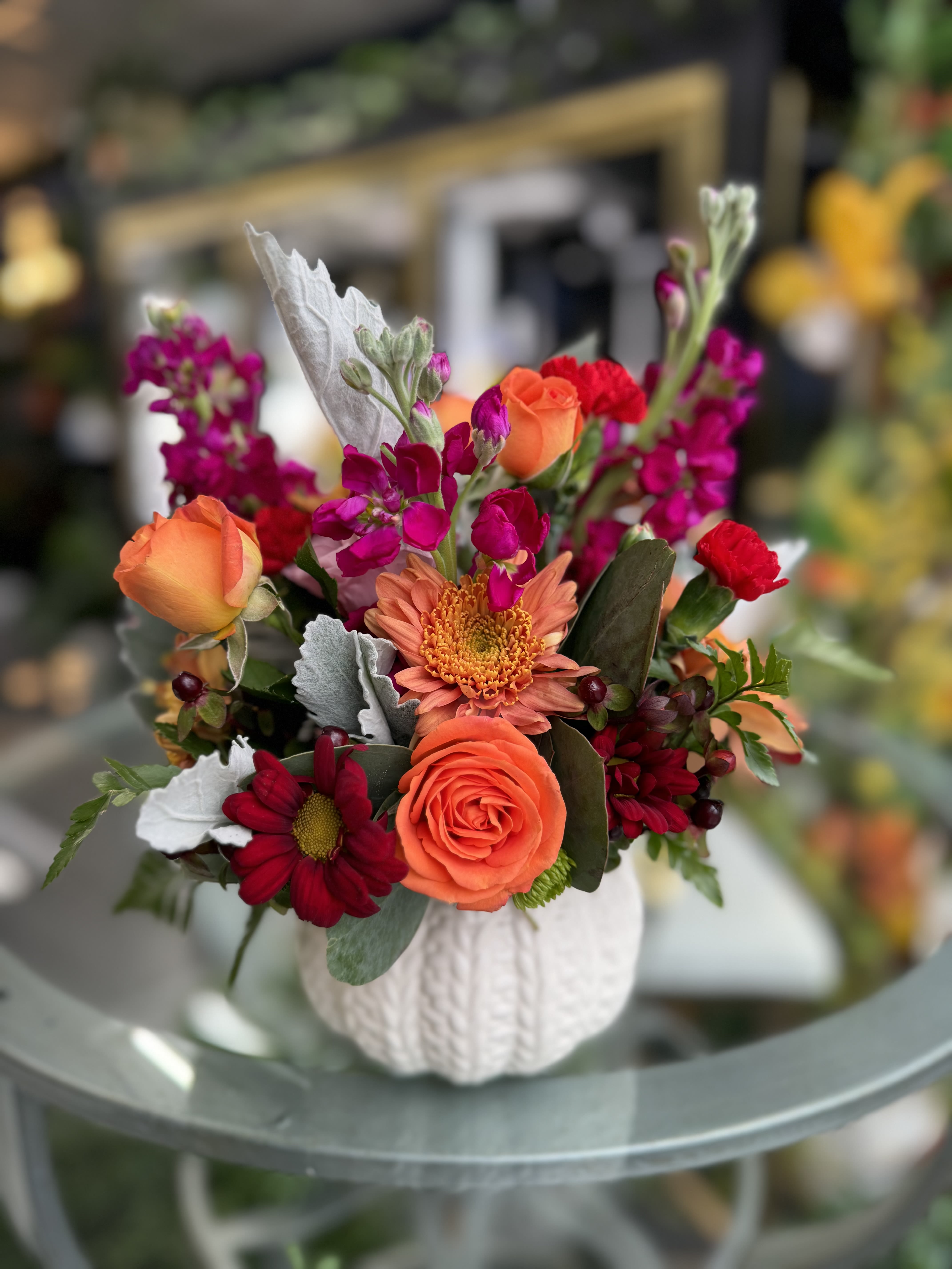 Autumn Charm - “A delightful pumpkin arrangement that captures the warmth of fall. Filled with fresh seasonal flowers in rich, cozy tones, this charming piece brings a touch of autumn into any space. Perfect for adding a seasonal vibe to your home or as a thoughtful gift for fall celebrations.” 10”hx8”w