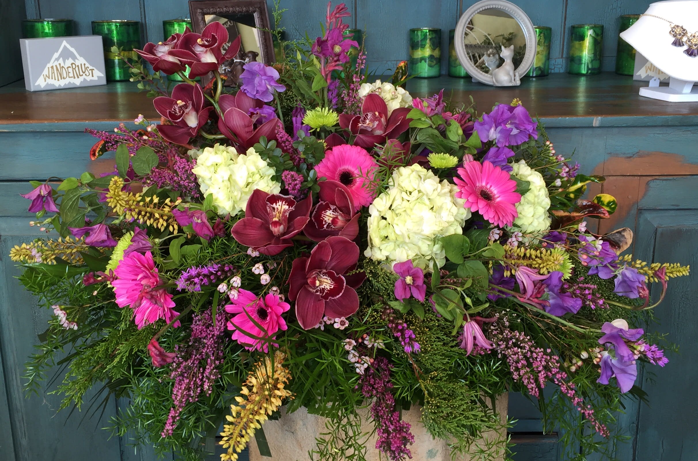 Large mixed floral arrangement with orchids, hydrangeas, and gerbera daisies