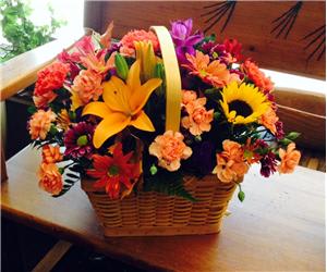 Autumn Basket - The perfect centerpiece for the holiday. A traditional centerpiece with bright autumn colors designed in a fall basket.