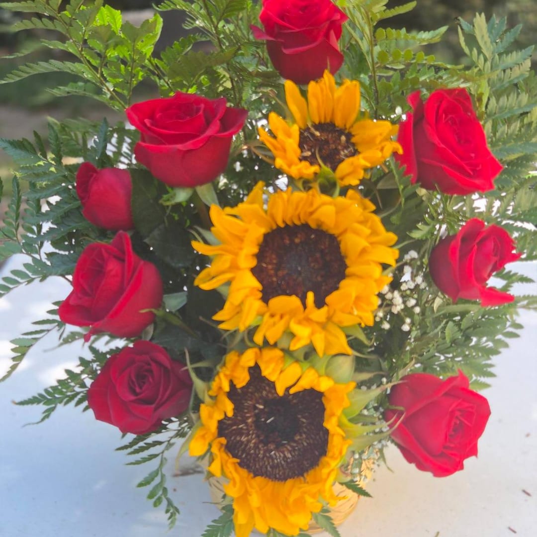 Bouquet of red roses and sunflowers